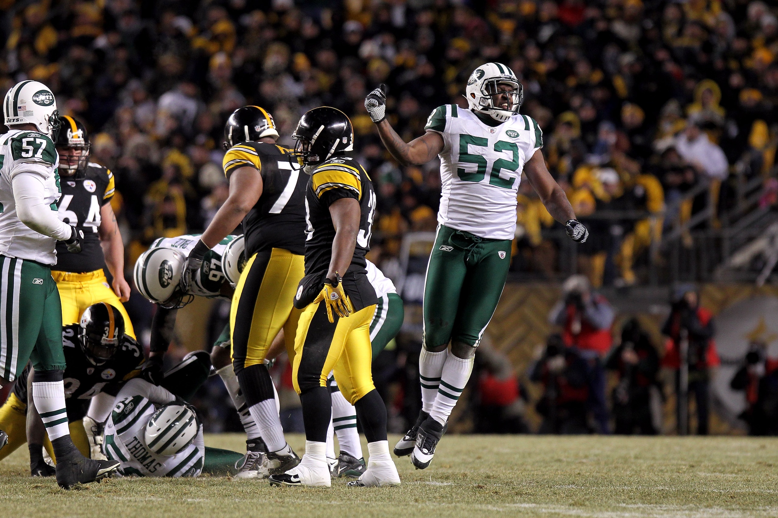 PITTSBURGH, PA - JANUARY 23:  David Harris #52 of the New York Jets reacts after an interception by Bryan Thomas #58 against the Pittsburgh Steelers during the 2011 AFC Championship game at Heinz Field on January 23, 2011 in Pittsburgh, Pennsylvania. The