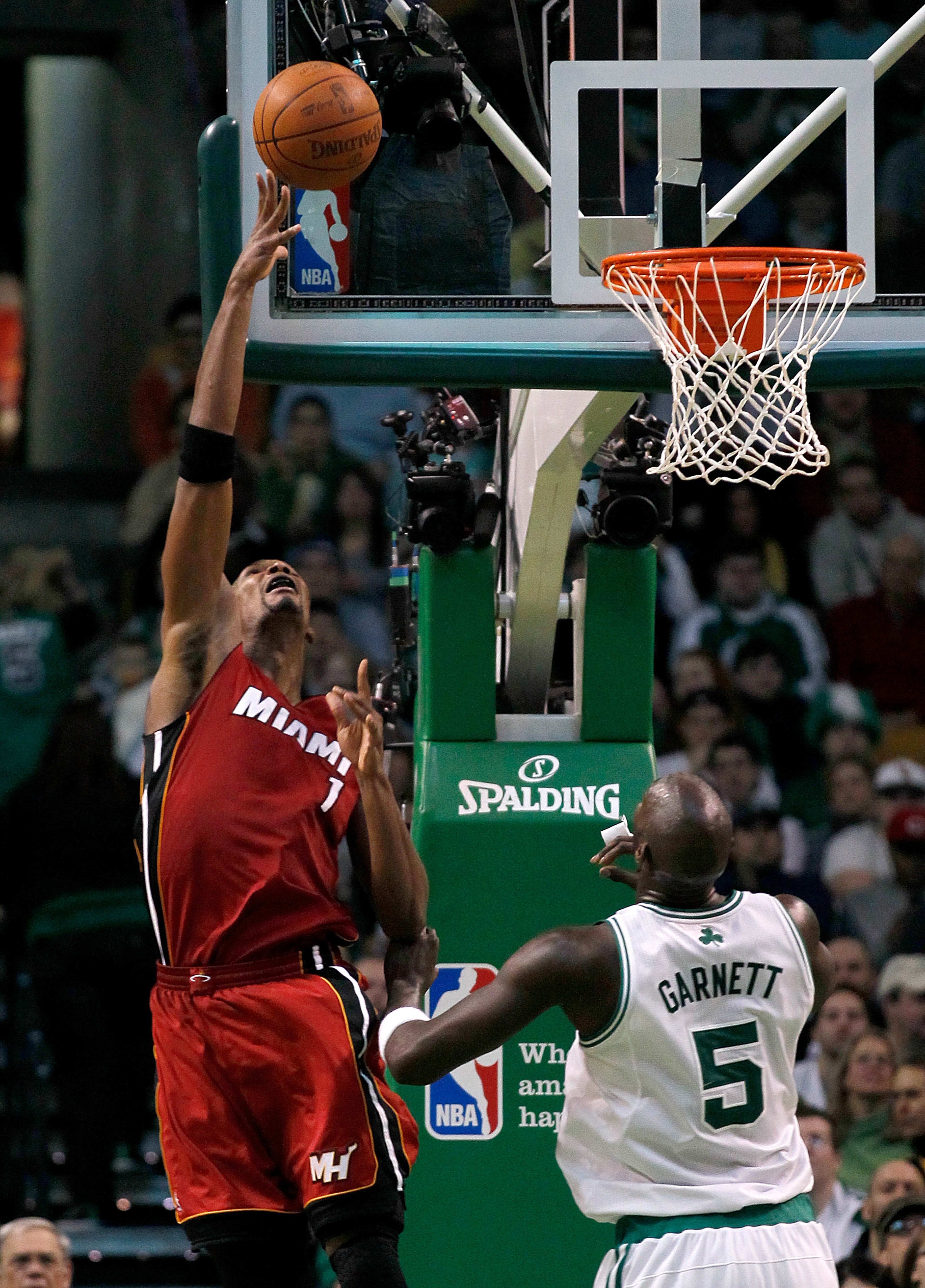 BOSTON - FEBRUARY 13:  Chris Bosh #1 of the Miami Heat goes to the basket against Kevin Garnett #5 of the Boston Celtics at TD Garden on February 13, 2011 in Boston, Massachusetts. NOTE TO USER: User expressly acknowledges and agrees that, by downloading