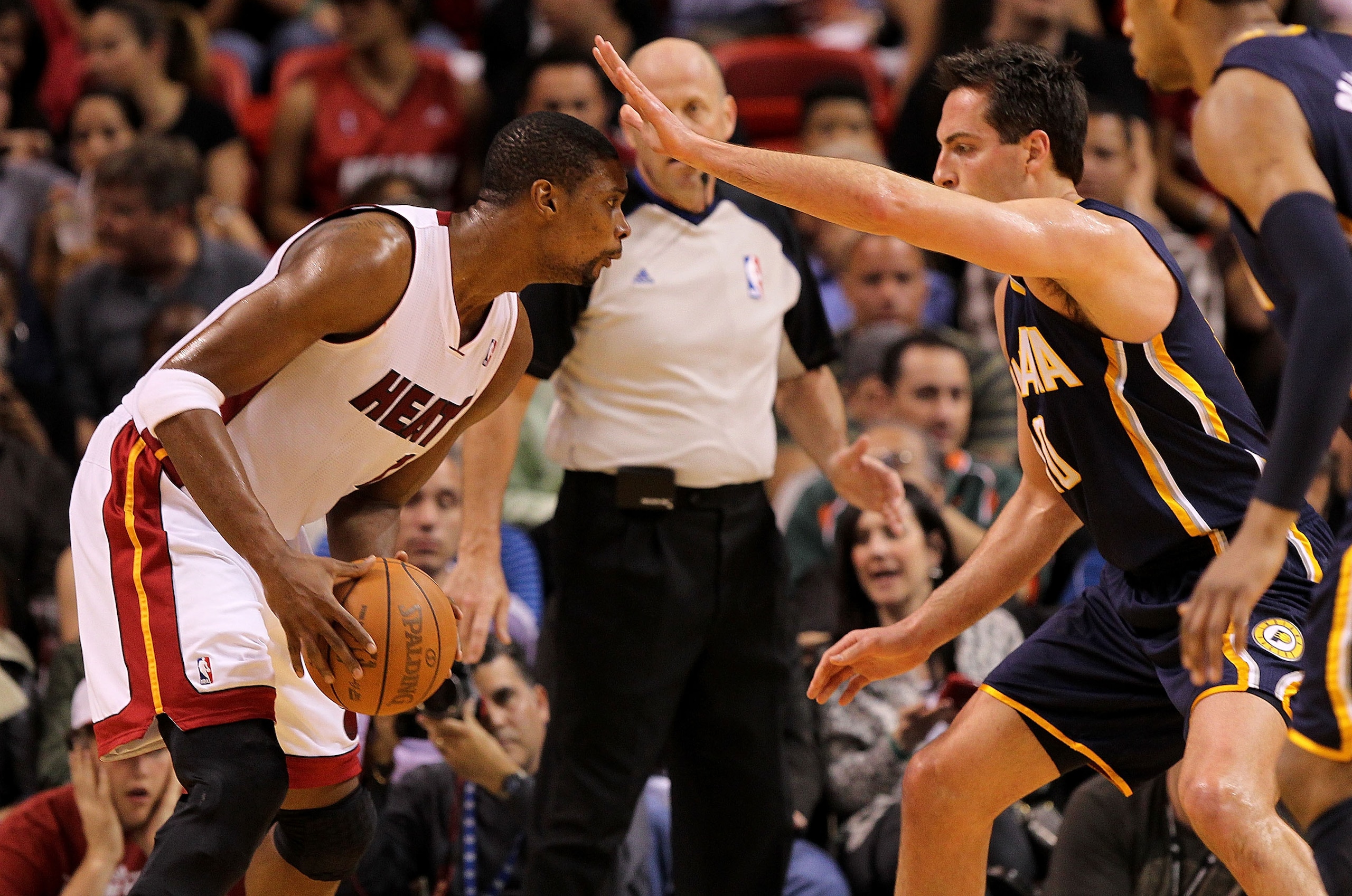 MIAMI, FL - FEBRUARY 08:  Chris Bosh #1 of the Miami Heat is guarded by Jeff Foster #10 of the Indiana Pacers during a game at American Airlines Arena on February 8, 2011 in Miami, Florida. NOTE TO USER: User expressly acknowledges and agrees that, by dow
