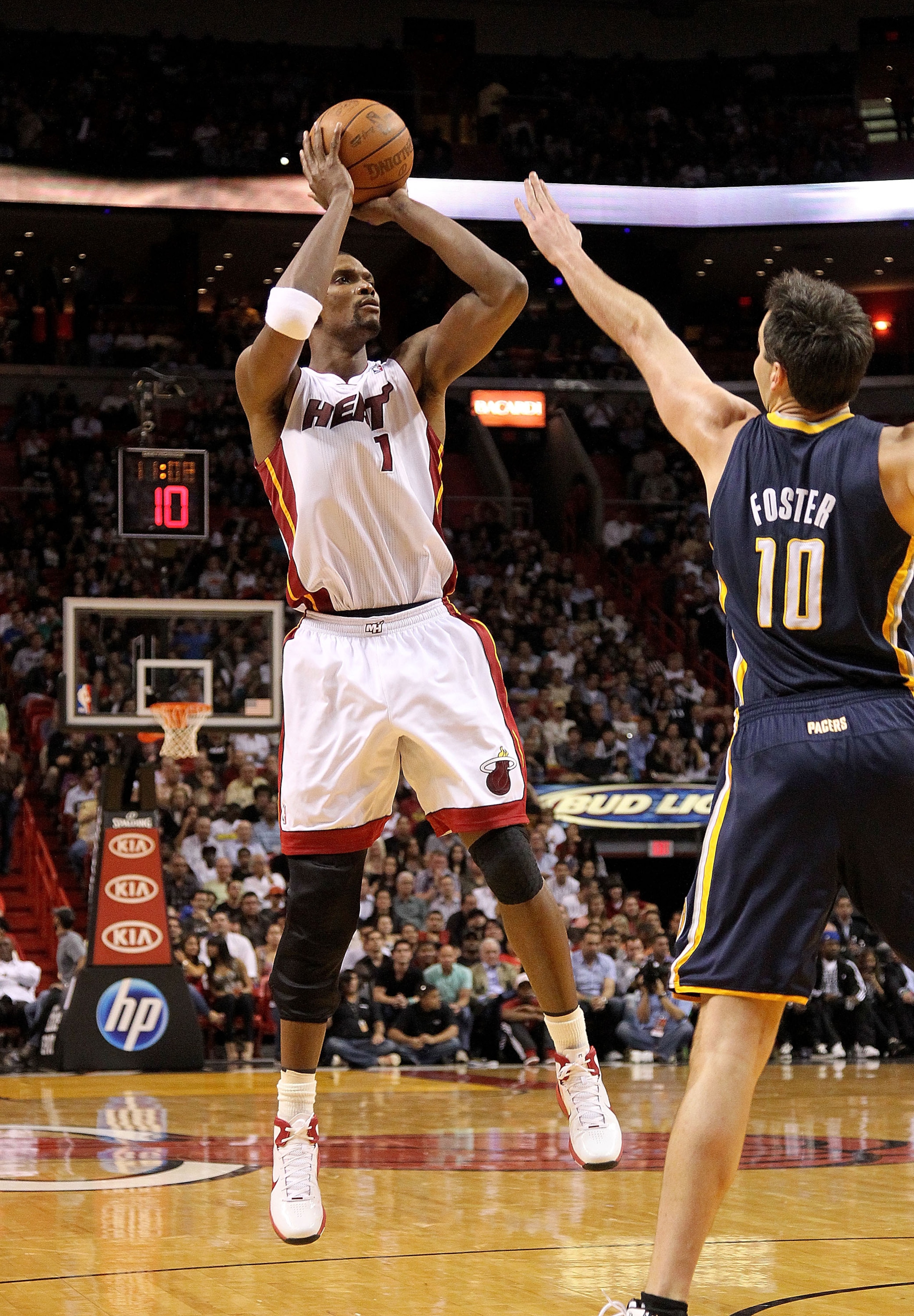 MIAMI, FL - FEBRUARY 08: Chris Bosh #1 of the Miami Heat shoots over Jeff Foster #10 of the Indiana Pacers during a game at American Airlines Arena on February 8, 2011 in Miami, Florida. NOTE TO USER: User expressly acknowledges and agrees that, by downlo
