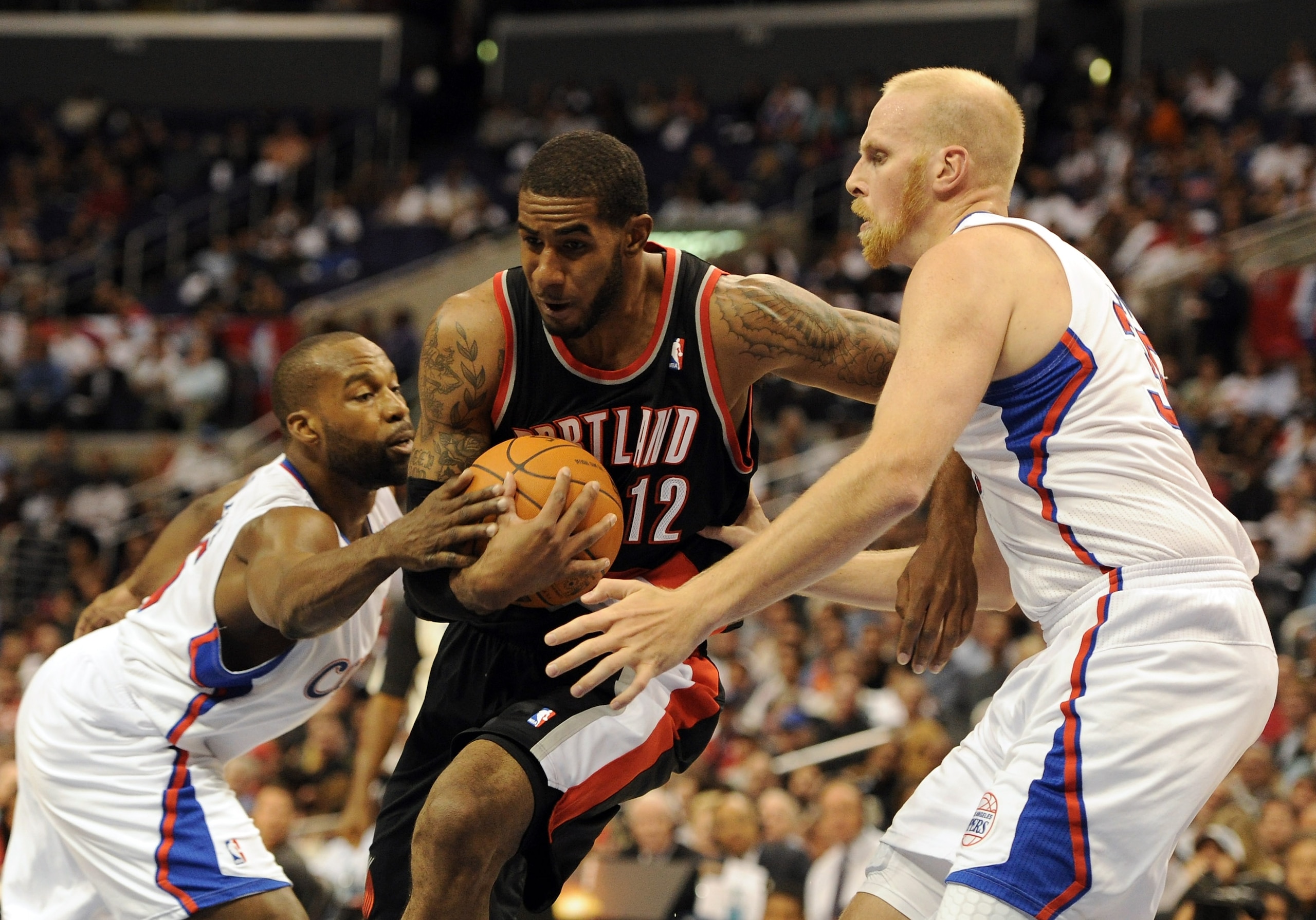 LOS ANGELES, CA - OCTOBER 27:  LaMarcus Aldridge #12 of the Portland Trail Blazers splits the defense of Baron Davis #5 and Chris Kaman #35 of the Los Angeles Clippers during a 98-88 Blazer win at Staples Center on October 27, 2010 in Los Angeles, Califor