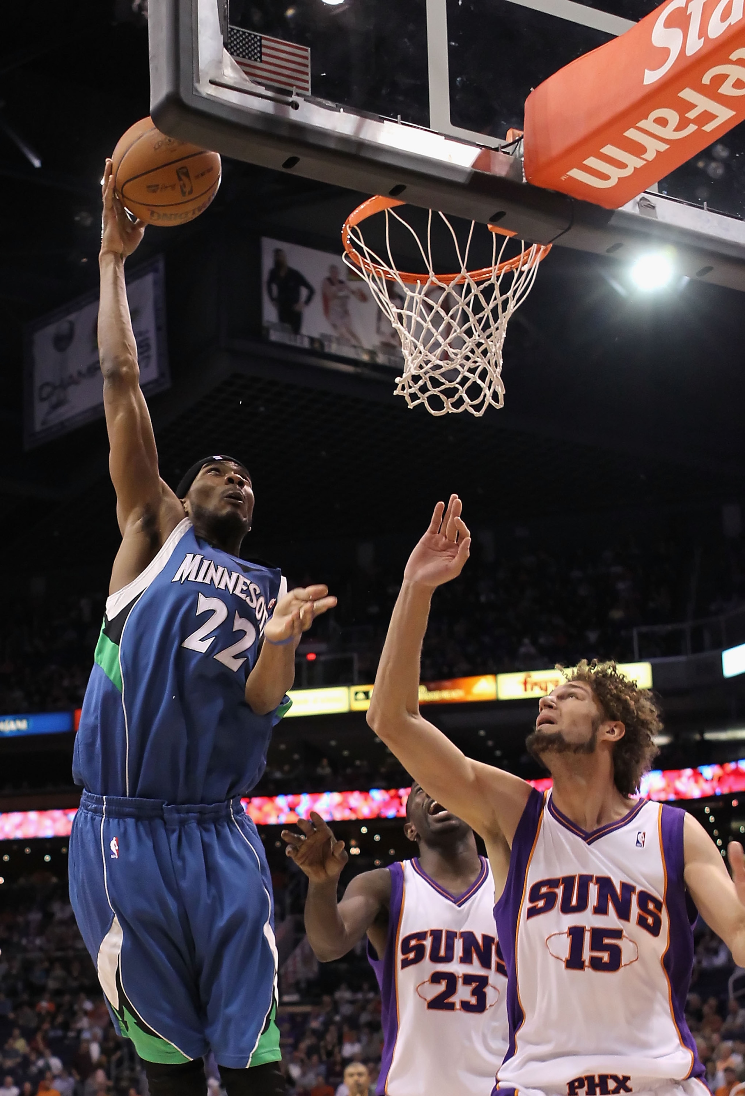 PHOENIX - MARCH 16:  Corey Brewer #22 of the Minnesota Timberwolves puts up a shot over Robin Lopez #15 of the Phoenix Suns during the NBA game at US Airways Center on March 16, 2010 in Phoenix, Arizona.  The Suns defeated the Timberwolves 152-114.  NOTE