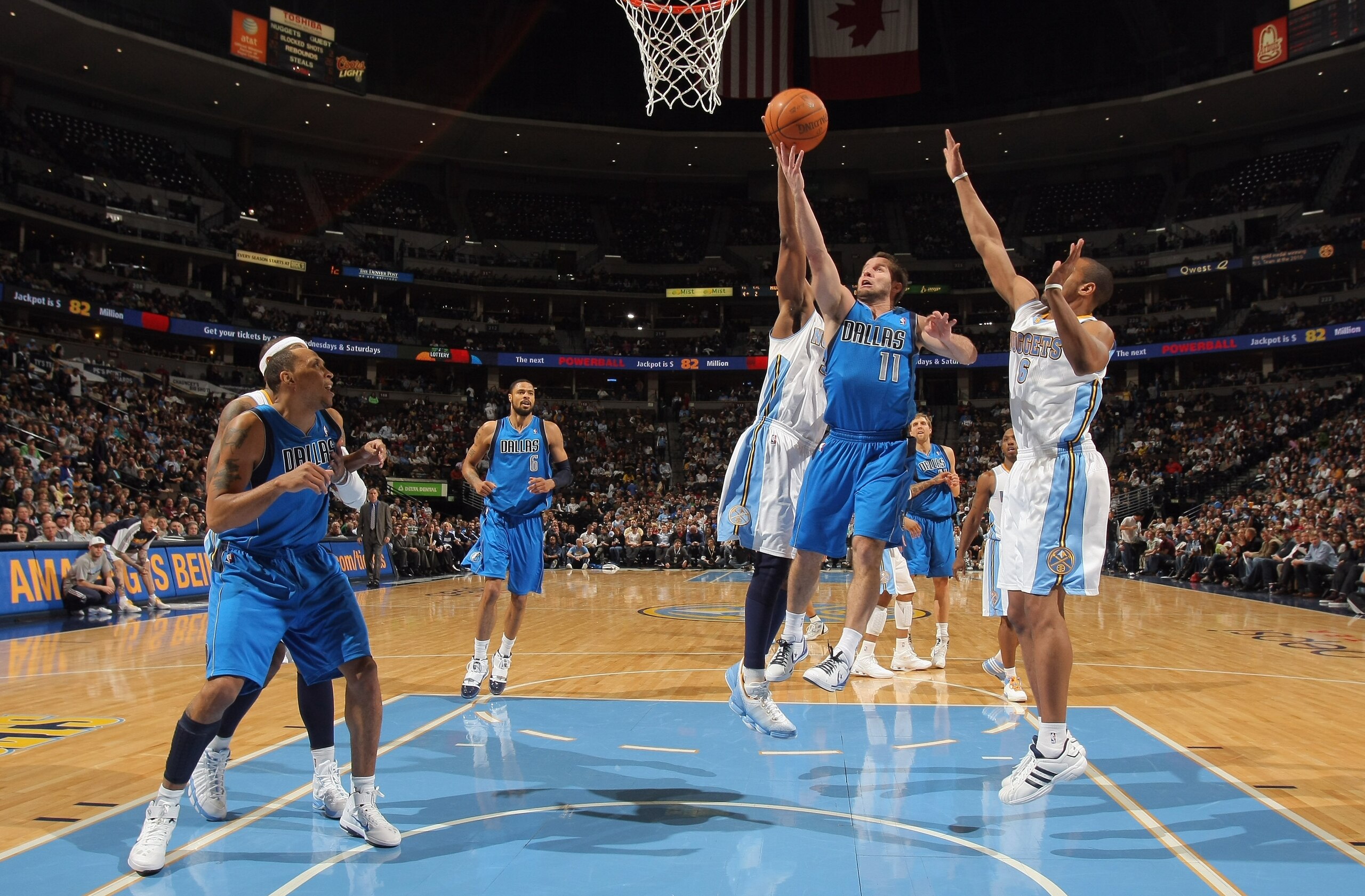 DENVER, CO - FEBRUARY 10:  Jose Barea #11 of the Dallas Mavericks lays up a shot between Nene #31 and Arron Afflalo #6 of the Denver Nuggets during NBA action at the Pepsi Center on February 10, 2011 in Denver, Colorado. NOTE TO USER: User expressly ackno