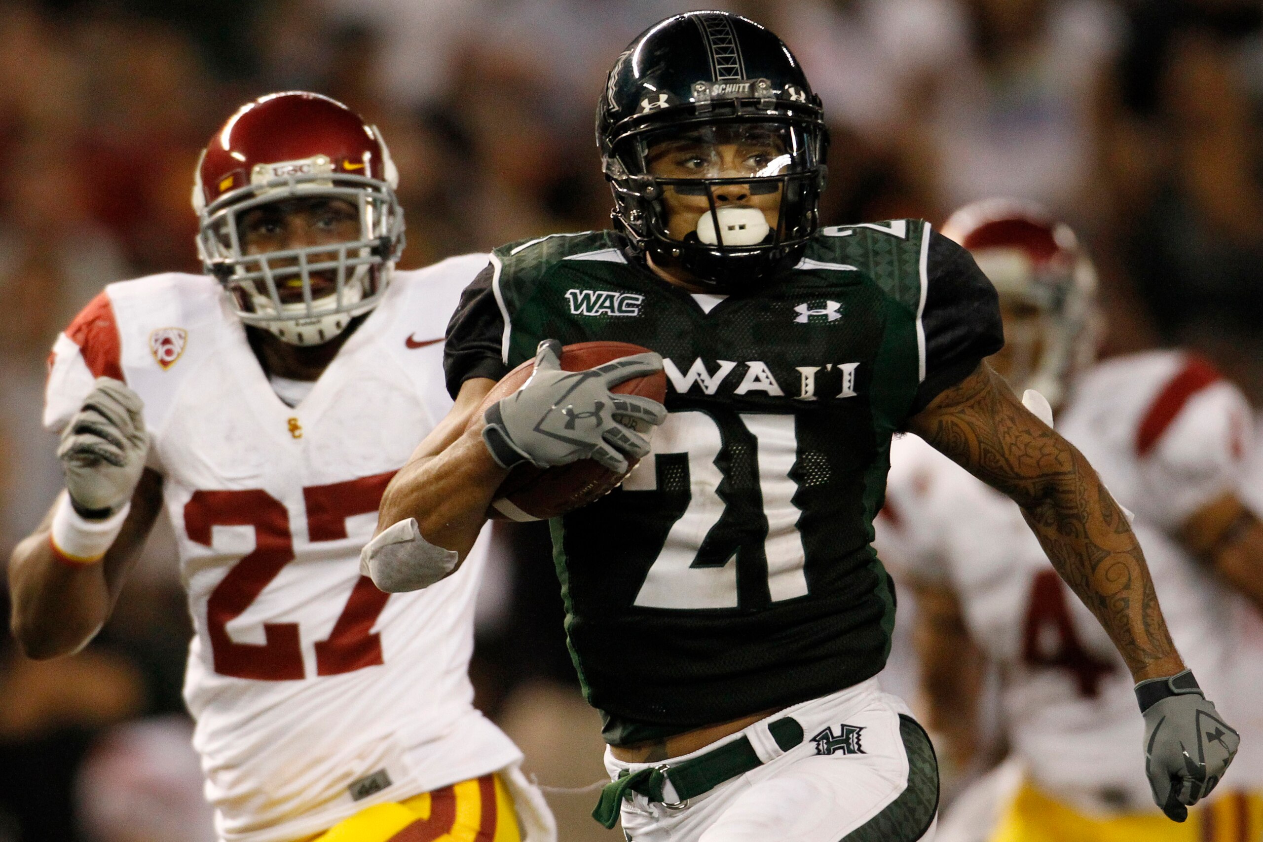 HONOLULU - SEPTEMBER 02: Kealoha Pilares #21 of the University of Hawaii Warriors carries the ball during second half action second half action at Aloha Stadium September 2, 2010 in Honolulu, Hawaii. (Photo by Kent Nishimura/Getty Images) HONOLULU - SEPTEMBER 02: Kealoha Pilares #21 of the University of Hawaii Warriors carries the ball during second half action second half action at Aloha Stadium September 2, 2010 in Honolulu, Hawaii. (Photo by Kent Nishimura/Getty Images)