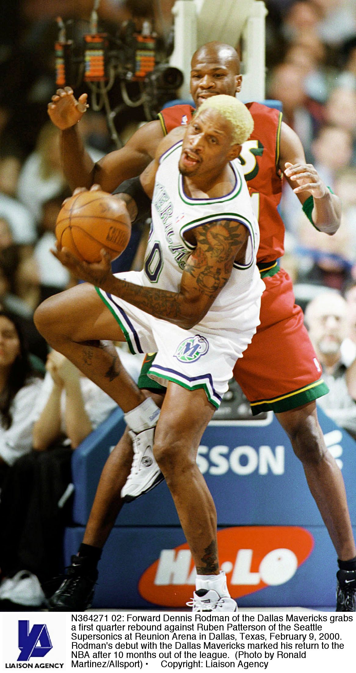 N364271 02: Forward Dennis Rodman of the Dallas Mavericks grabs a first quarter rebound against Ruben Patterson of the Seattle Supersonics at Reunion Arena in Dallas, Texas, February 9, 2000. Rodman's debut with the Dallas Mavericks marked his return to t