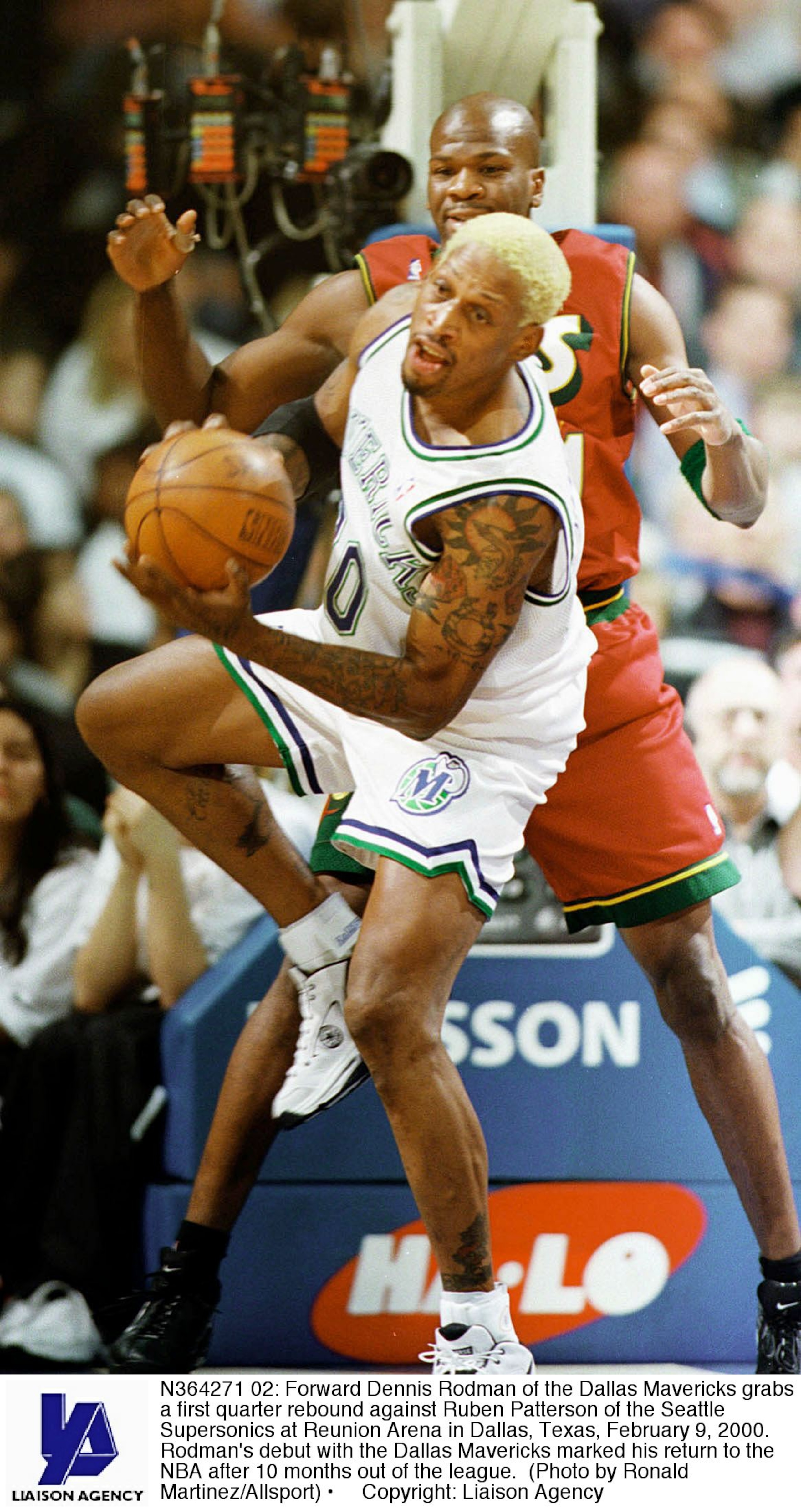 N364271 02: Forward Dennis Rodman of the Dallas Mavericks grabs a first quarter rebound against Ruben Patterson of the Seattle Supersonics at Reunion Arena in Dallas, Texas, February 9, 2000. Rodman's debut with the Dallas Mavericks marked his return to t