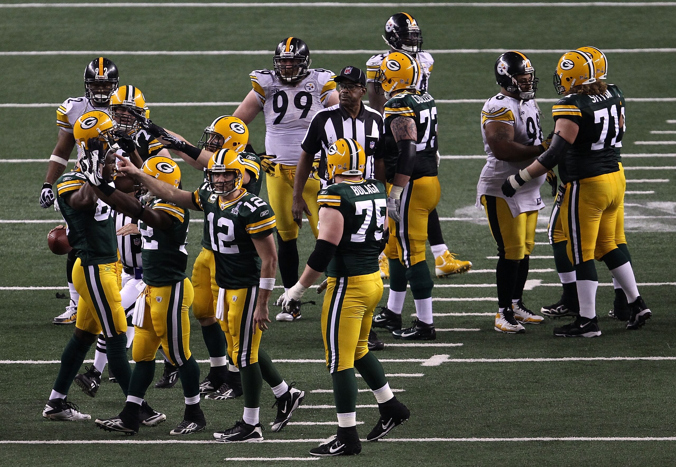 ARLINGTON, TX - FEBRUARY 06:  Brandon Jackson #32 and Aaron Rodgers #12 of the Green Bay Packers celebrate as the Packers defeat the Pittsburgh Steelers 31-25 to win Super Bowl XLV at Cowboys Stadium on February 6, 2011 in Arlington, Texas.  (Photo by Jon