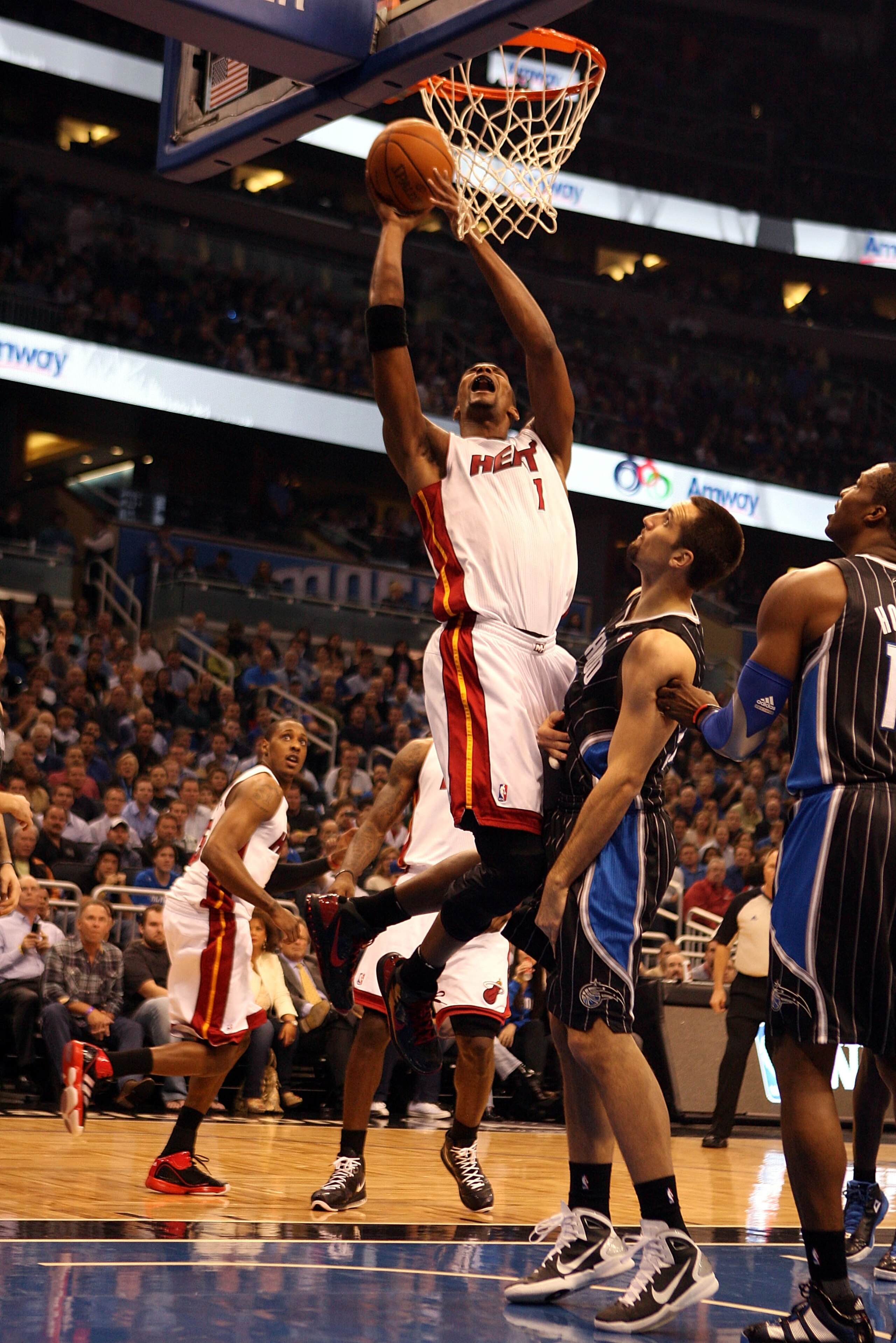 ORLANDO, FL - FEBRUARY 03:  Center Chris Bosh #1  of the Miami Heat shoots against the Orlando Magic at Amway Arena on February 3, 2011 in Orlando, Florida. NOTE TO USER: User expressly acknowledges and agrees that, by downloading and or using this photog
