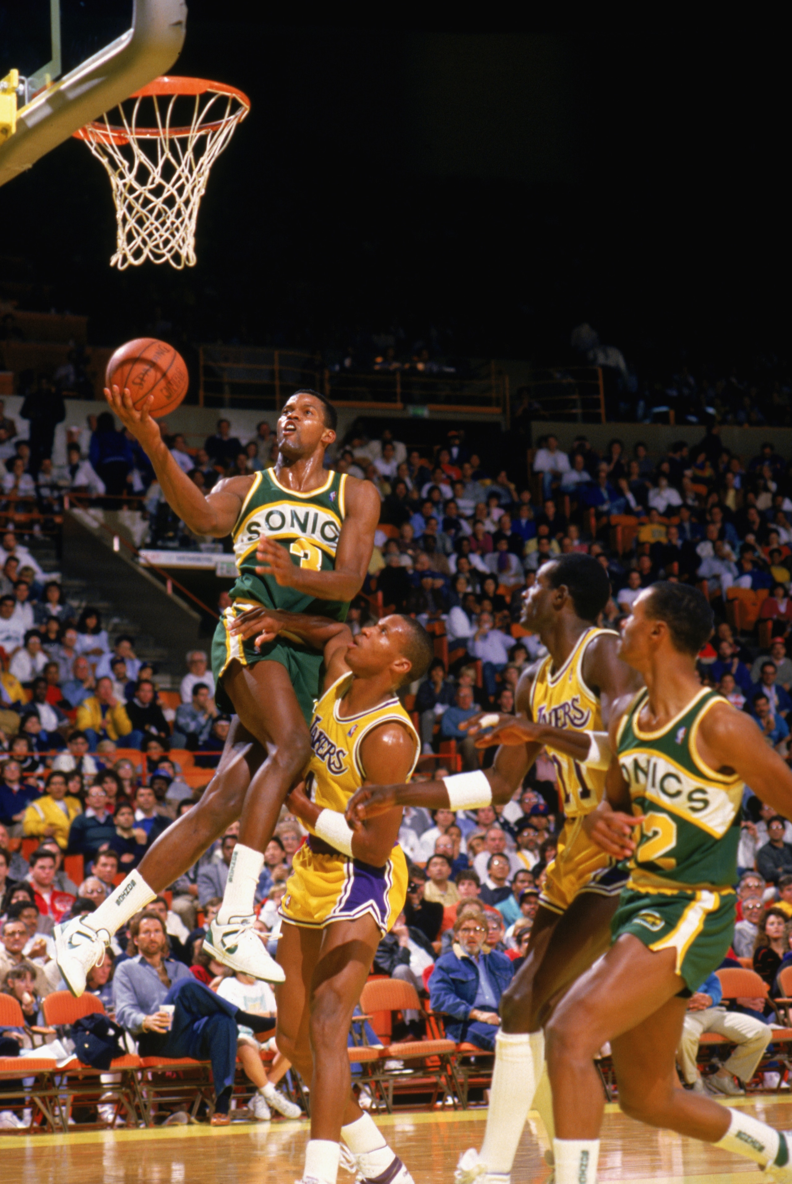 LOS ANGELES - 1987:  Dale Ellis #3 of the Seattle Supersonics takes the ball to the basket against Byron Scott #4 of the Los Angeles Lakers during a game in the 1987-1988 NBA season at the Great Western Forum in Los Angeles, California.  (Photo by Mike Po