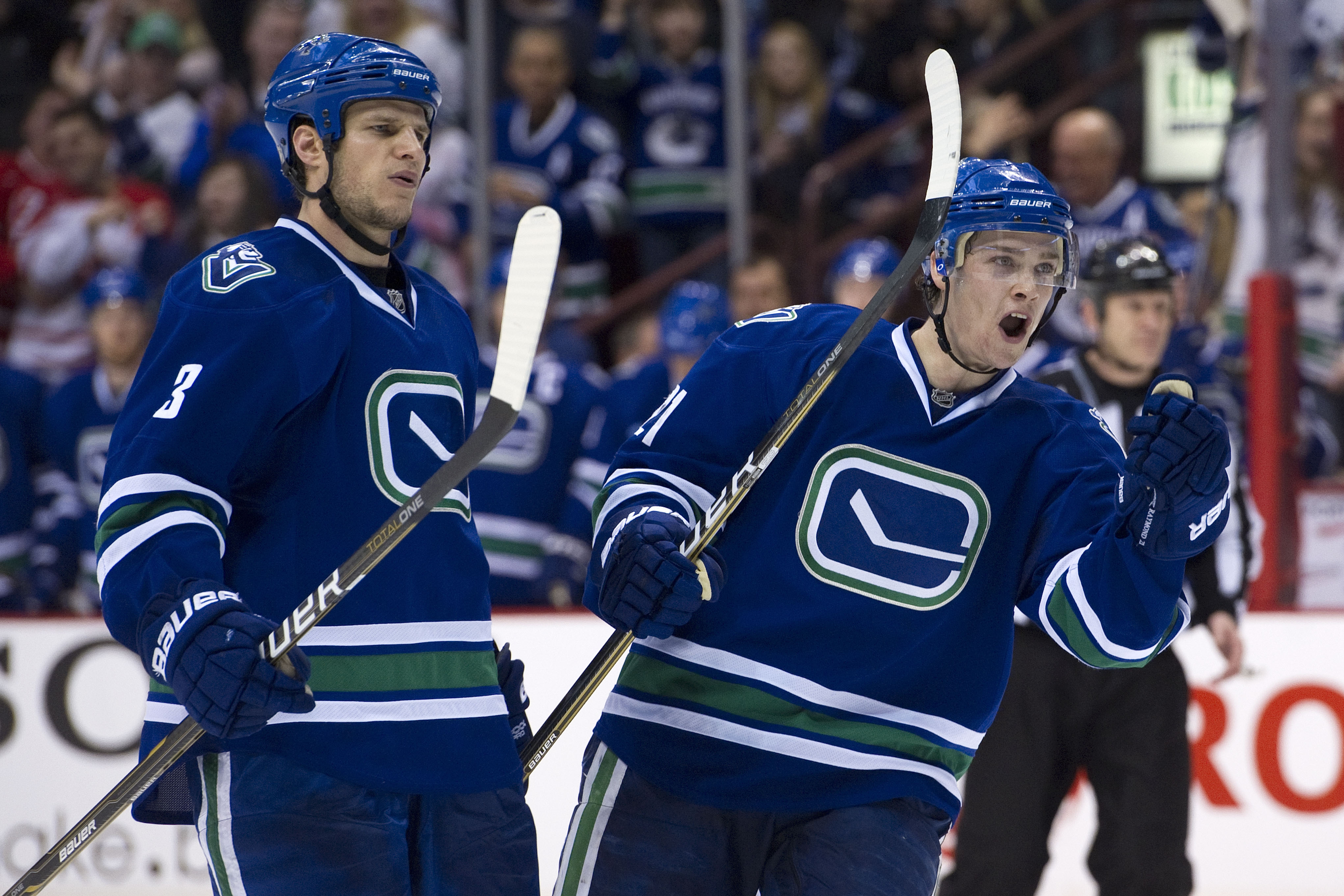 VANCOUVER, CANADA - FEBRUARY 12: Kevin Bieksa #3 and Mason Raymond #21 of the Vancouver Canucks celebrate teammate Mikael Samuelsson's #26 goal against the Calgary Flames during the second period in NHL action on February 12, 2011 at Rogers Arena in Vanco