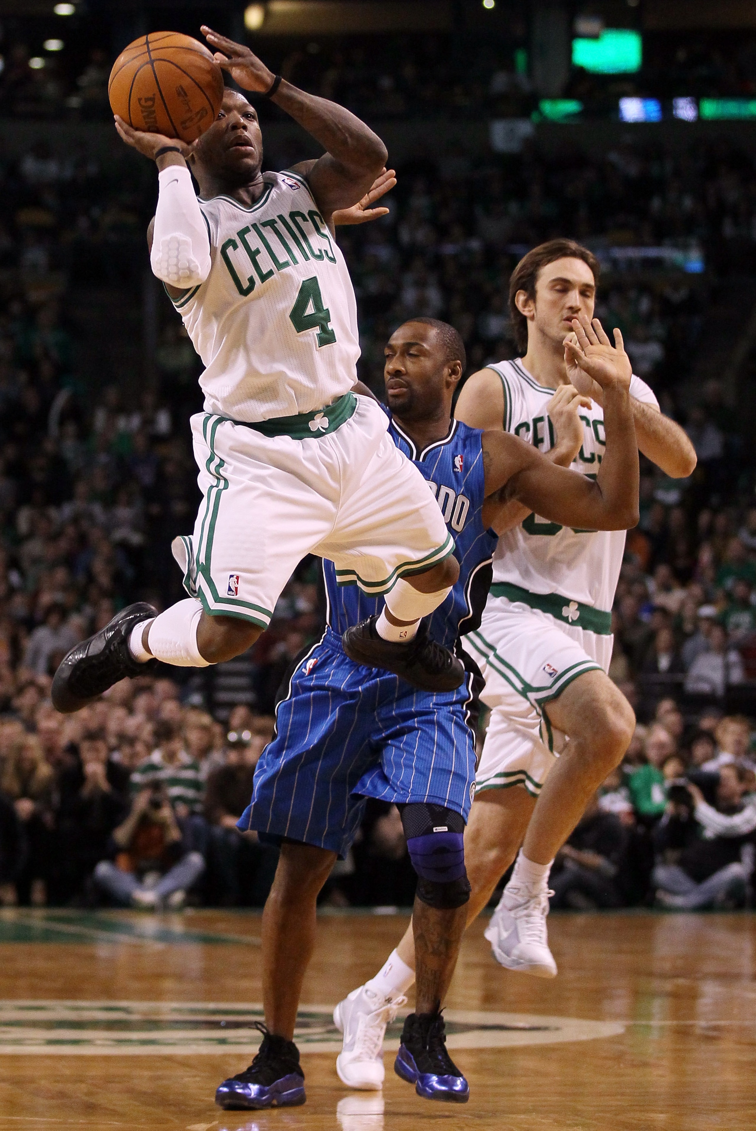 BOSTON, MA - FEBRUARY 06:  Nate Robinson #4 of the Boston Celtics takes a shot as Gilbert Arenas #1 of the Orlando Magic defends on February 6, 2011 at the TD Garden in Boston, Massachusetts. The Celtics defeated the Magic 91-80. NOTE TO USER: User expres