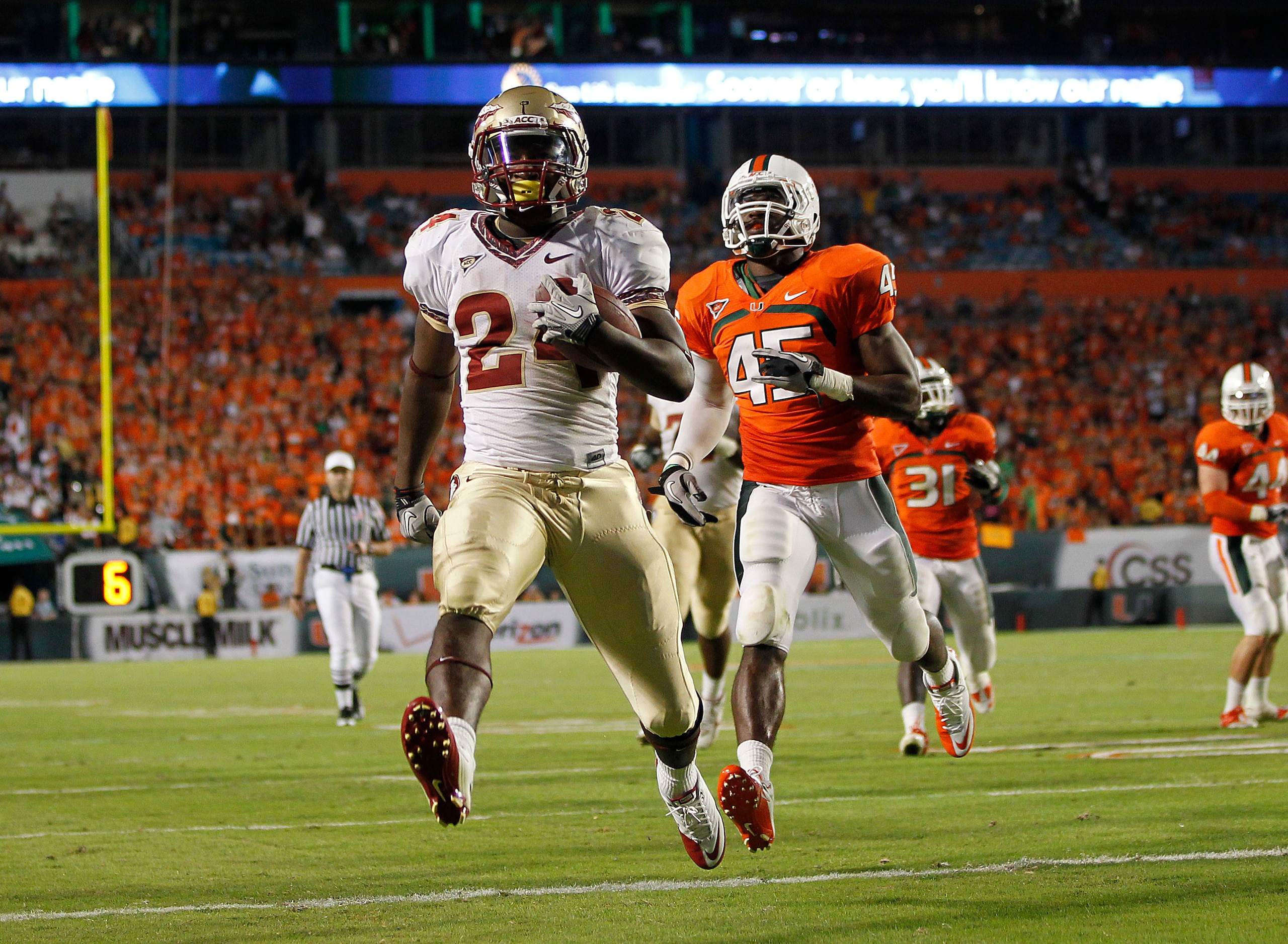 MIAMI, FL - OCTOBER 9: Lonnie Pryor #24 of the Florida State Seminoles scores a touchdown while being pursued by Ramon Buchanan #45 of the Miami Hurricanes on October 9, 2010 at Sun Life Stadium in Miami, Florida. The Seminoles defeated the Hurricanes 45- MIAMI, FL - OCTOBER 9: Lonnie Pryor #24 of the Florida State Seminoles scores a touchdown while being pursued by Ramon Buchanan #45 of the Miami Hurricanes on October 9, 2010 at Sun Life Stadium in Miami, Florida. The Seminoles defeated the Hurricanes 45-