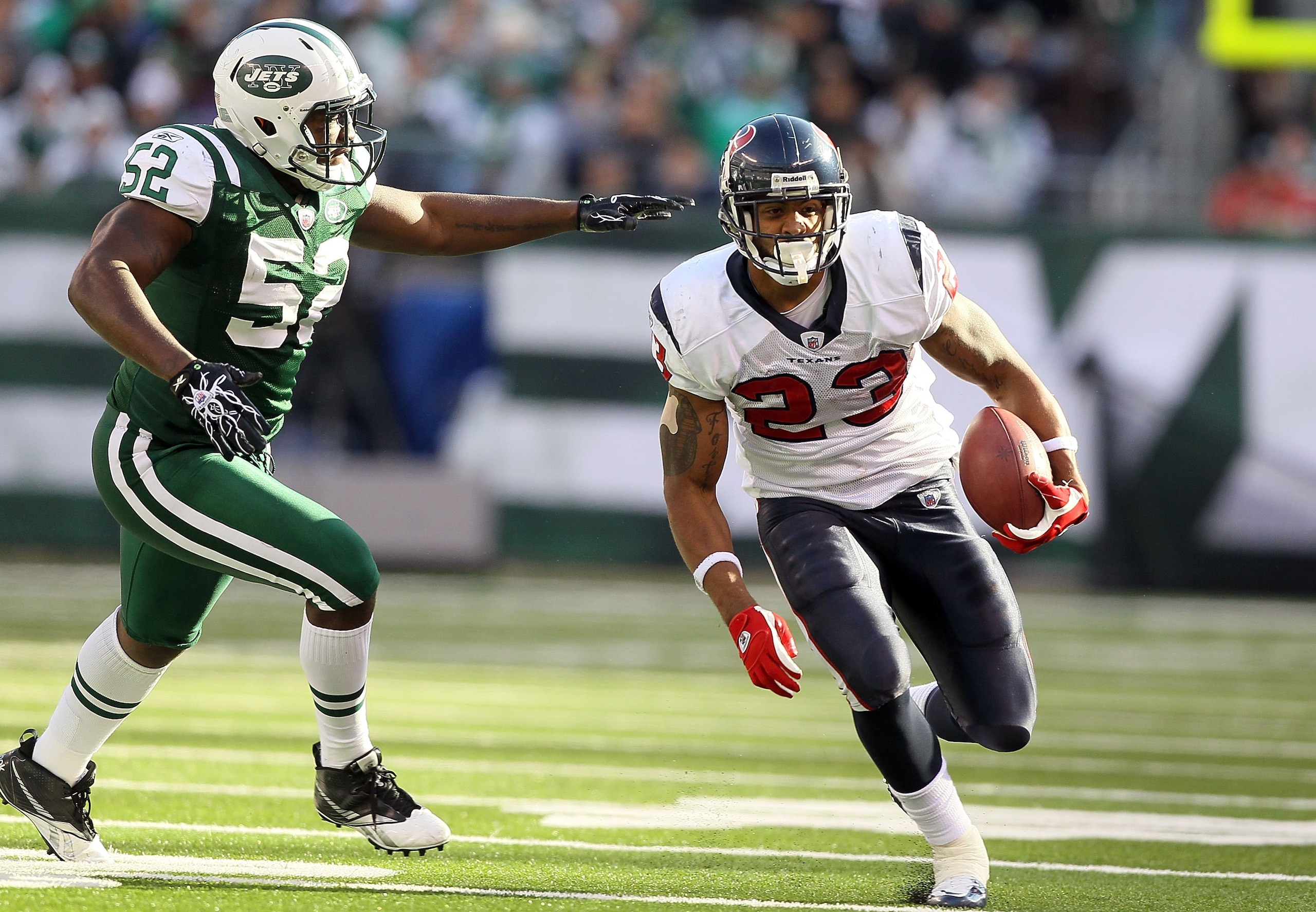 EAST RUTHERFORD, NJ - NOVEMBER 21:  Arian Foster #23 of the Houston Texans runs the ball against David Harris #52 of the New York Jets on November 21, 2010 at the New Meadowlands Stadium in East Rutherford, New Jersey.  (Photo by Jim McIsaac/Getty Images)