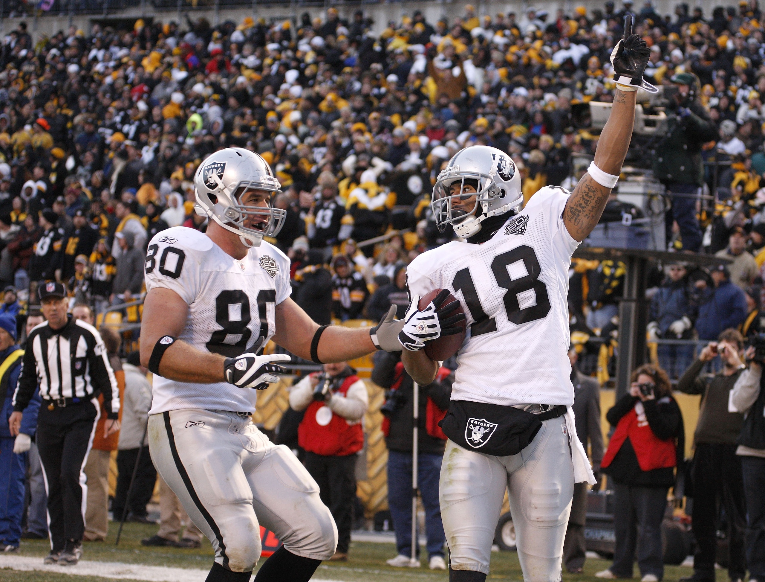 PITTSBURGH - DECEMBER 06:  Louis Murphy #18 of the Oakland Raiders celebrates the game winning touchdown with Zach Miller #80 while playing the Pittsburgh Steelers on December 6, 2009 at Heinz Field in Pittsburgh, Pennsylvania. Oakland won the game 27-24.