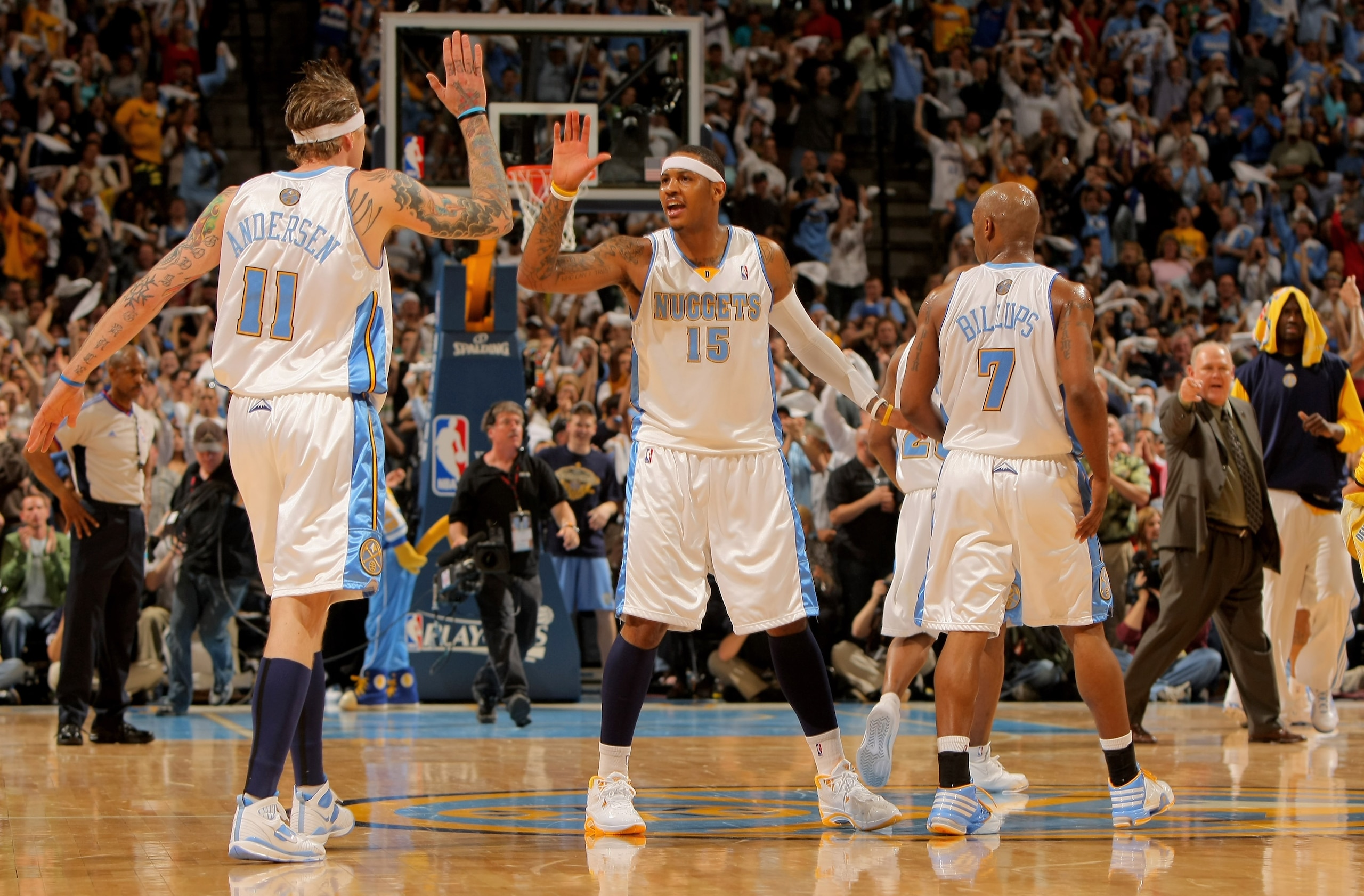 DENVER - MAY 03:  Chris Andersen #11, Carmelo Anthony #15 and Chauncey Billups #7 of the Denver Nuggets celebrate during a time out against the Dallas Mavericks in Game One of the Western Conference Semifinals during the 2009 NBA Playoffs at Pepsi Center