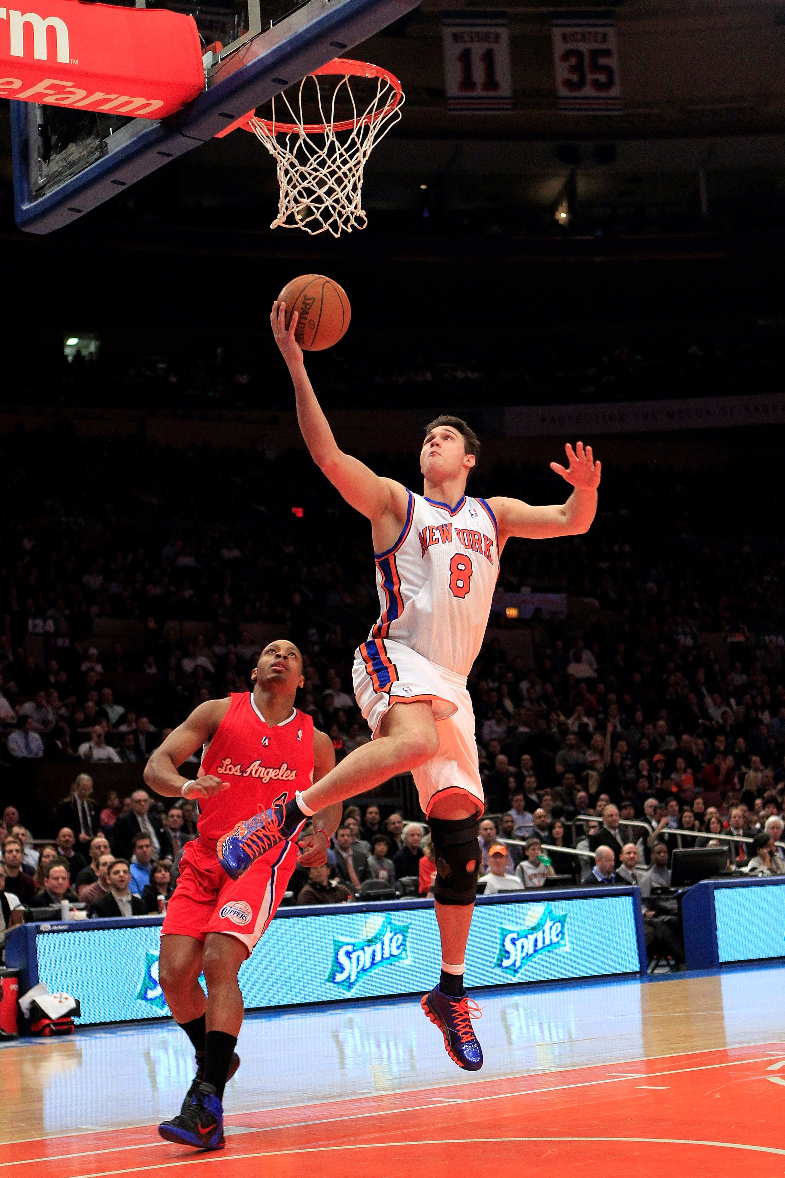 NEW YORK, NY - FEBRUARY 09:  Danilo Gallinari #8 of the New York Knicks lays the ball up over Randy Foye #4 of the Los Angeles Clippers at Madison Square Garden on February 9, 2011 in New York City. NOTE TO USER: User expressly acknowledges and agrees tha