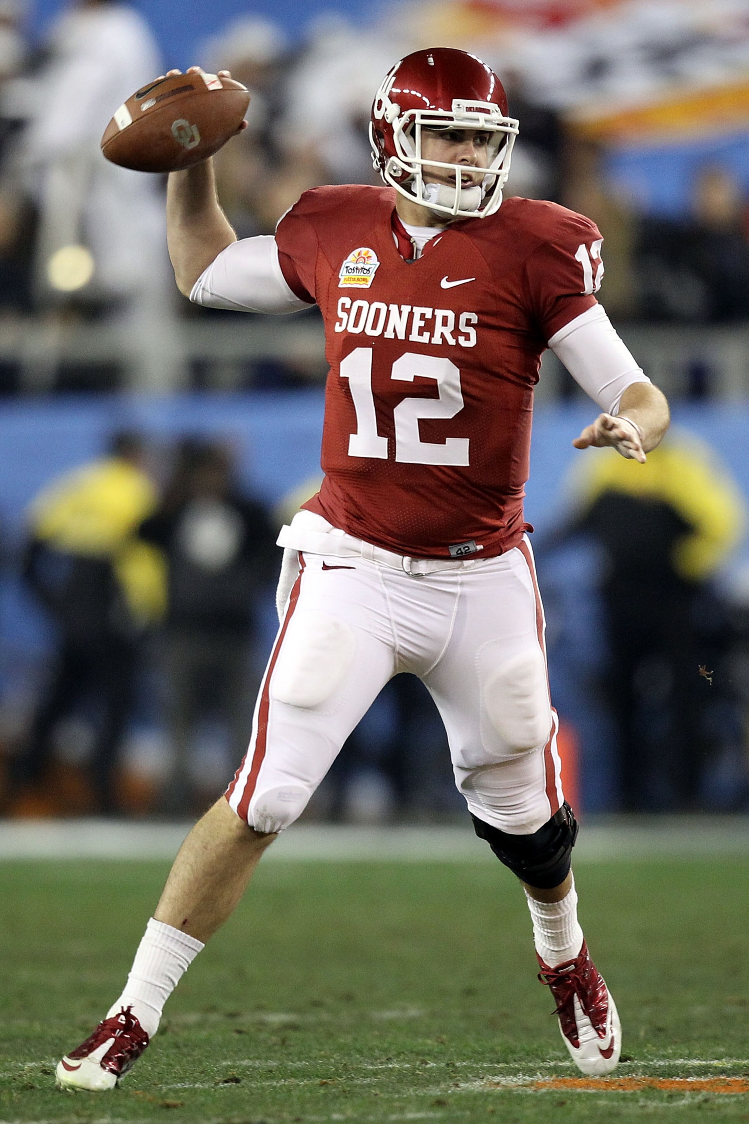GLENDALE, AZ - JANUARY 01:  Landry Jones #12 of the Oklahoma Sooners throws the ball against the Connecticut Huskies during the Tostitos Fiesta Bowl at the Universtity of Phoenix Stadium on January 1, 2011 in Glendale, Arizona.  (Photo by Christian Peters