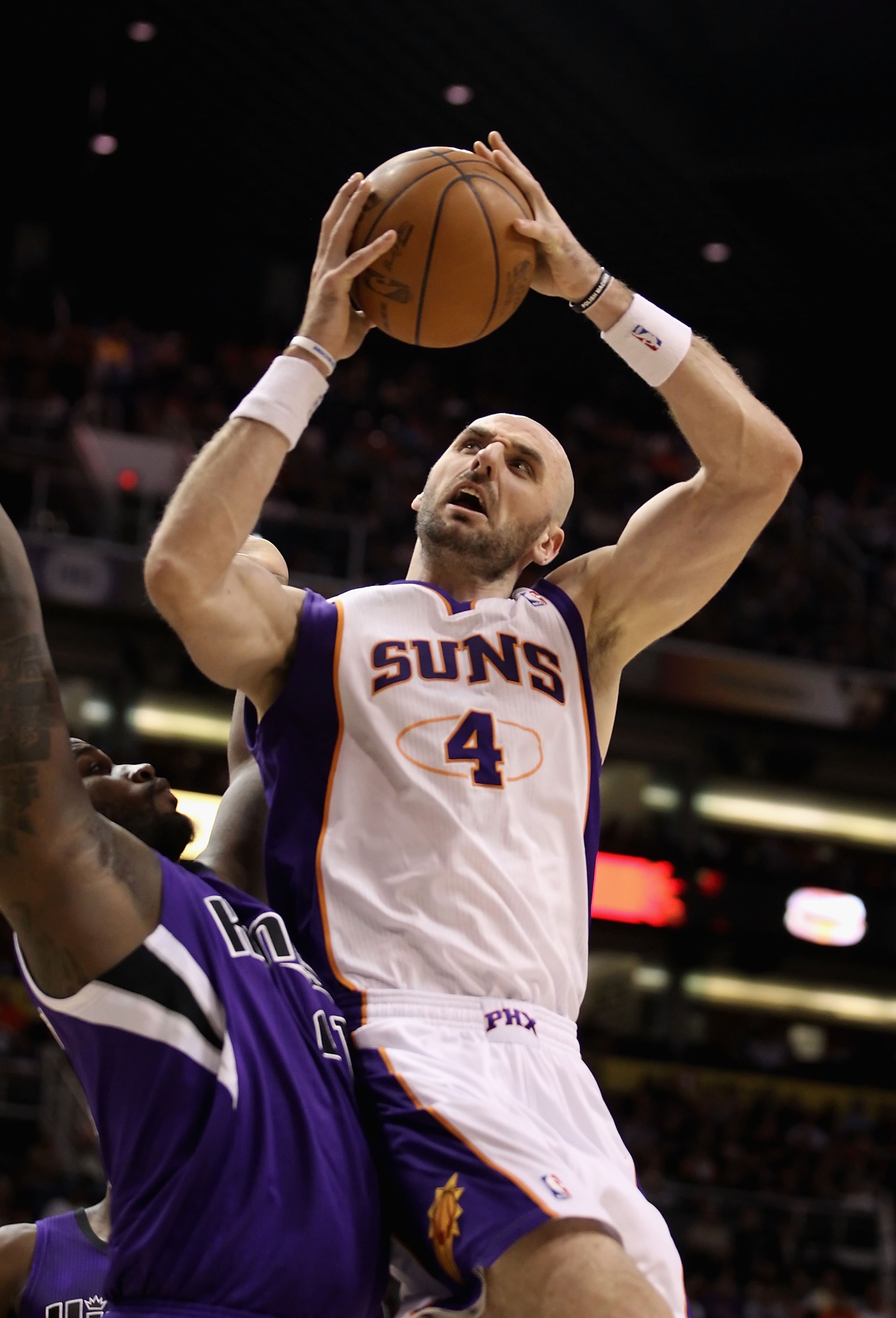 PHOENIX, AZ - FEBRUARY 13:  Marcin Gortat #4 of the Phoenix Suns attempts a shot against the Sacramento Kings during the NBA game at US Airways Center on February 13, 2011 in Phoenix, Arizona. The Kings defeated the Suns 113-108.  NOTE TO USER: User expre