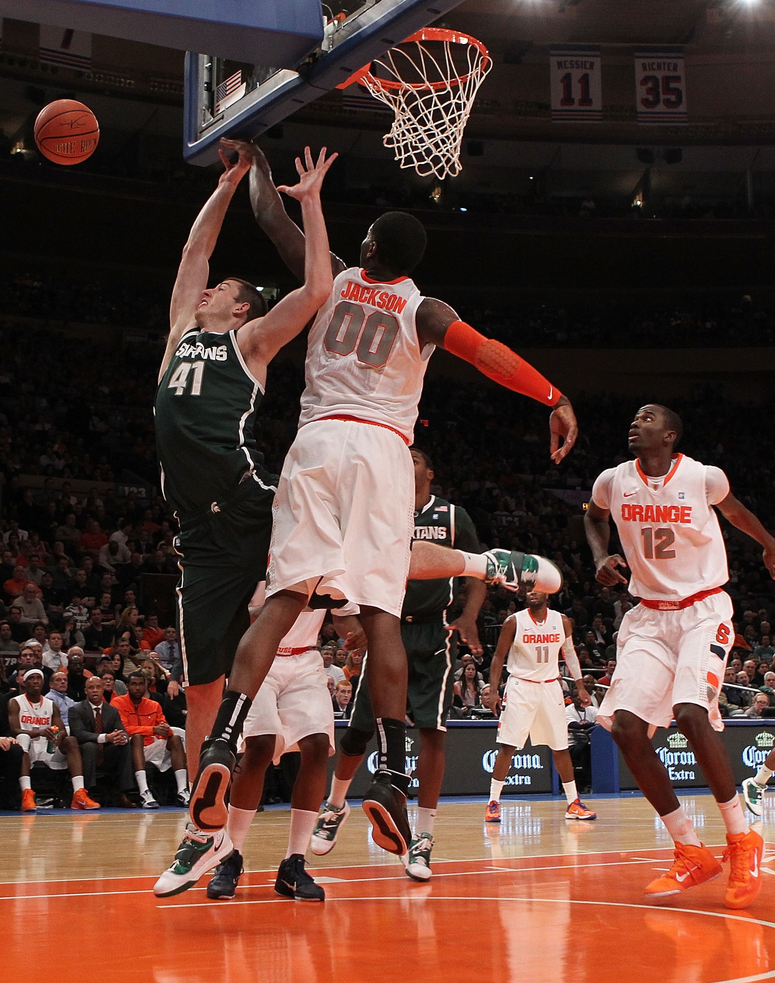 NEW YORK, NY - DECEMBER 07: Garrick Sherman #41 of the Michigan Spartans has his shot blocked by Rick Jackson #00 of Syracuse Orange during their game at the Jimmy V Classic at Madison Square Garden on December 7, 2010 in New York City.  (Photo by Nick La