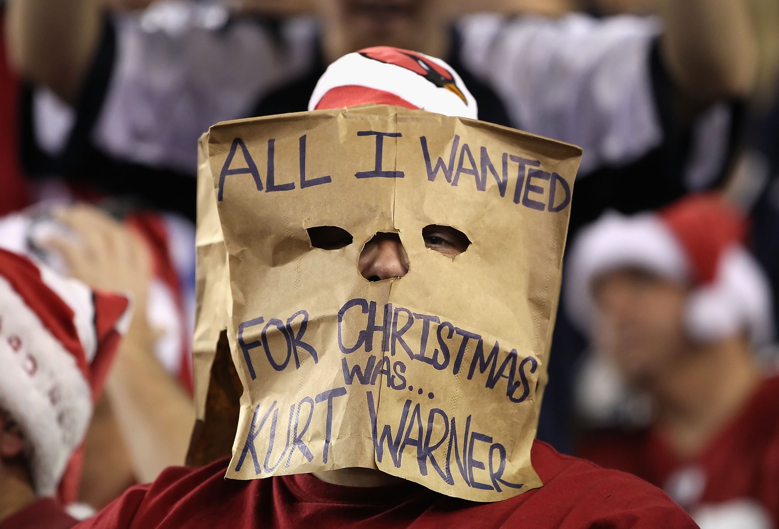 GLENDALE, AZ - DECEMBER 25: A fan of the Arizona Cardinals wears a bag on his head during the NFL game against the Dallas Cowboys at the University of Phoenix Stadium on December 25, 2010 in Glendale, Arizona. The Cardinals defeated the Cowboys 27-26. GLENDALE, AZ - DECEMBER 25: A fan of the Arizona Cardinals wears a bag on his head during the NFL game against the Dallas Cowboys at the University of Phoenix Stadium on December 25, 2010 in Glendale, Arizona. The Cardinals defeated the Cowboys 27-26.