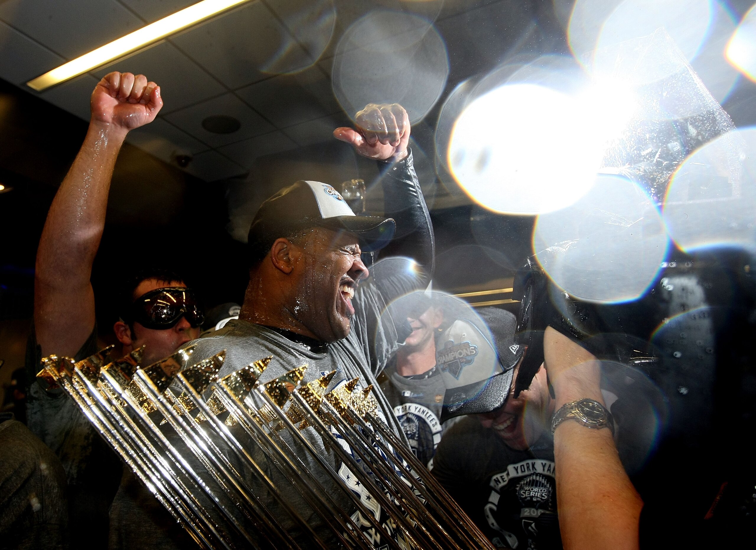NEW YORK - NOVEMBER 04:  C.C. Sabathia #52 of the New York Yankees celebrates with the trophy in the locker room after their 7-3 win against the Philadelphia Phillies in Game Six of the 2009 MLB World Series at Yankee Stadium on November 4, 2009 in the Br