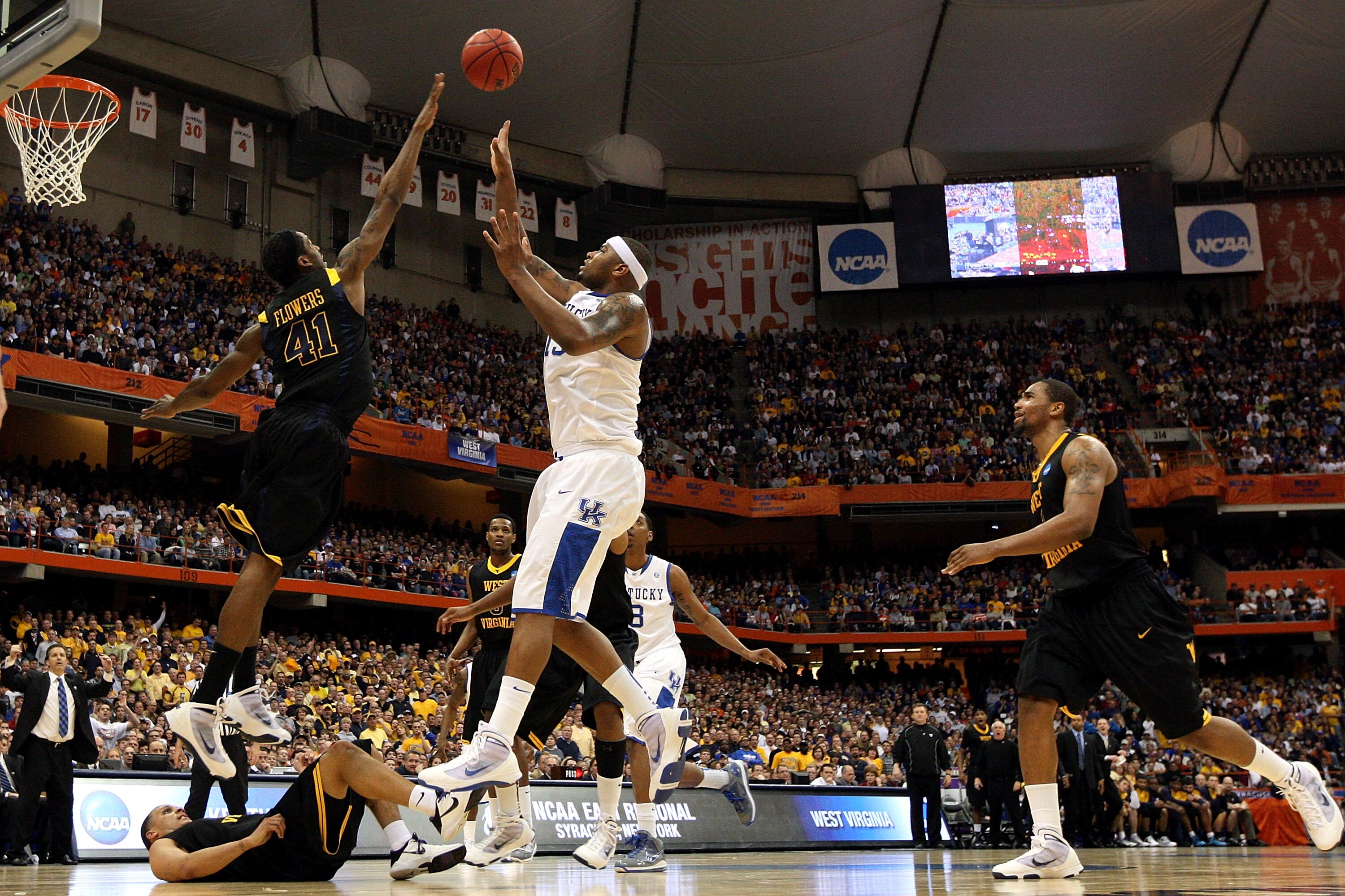 SYRACUSE, NY - MARCH 27:  DeMarcus Cousins #15 of the Kentucky Wildcats attempts a shot against John Flowers #41of the West Virginia Mountaineers during the east regional final of the 2010 NCAA men's basketball tournament at the Carrier Dome on March 27,