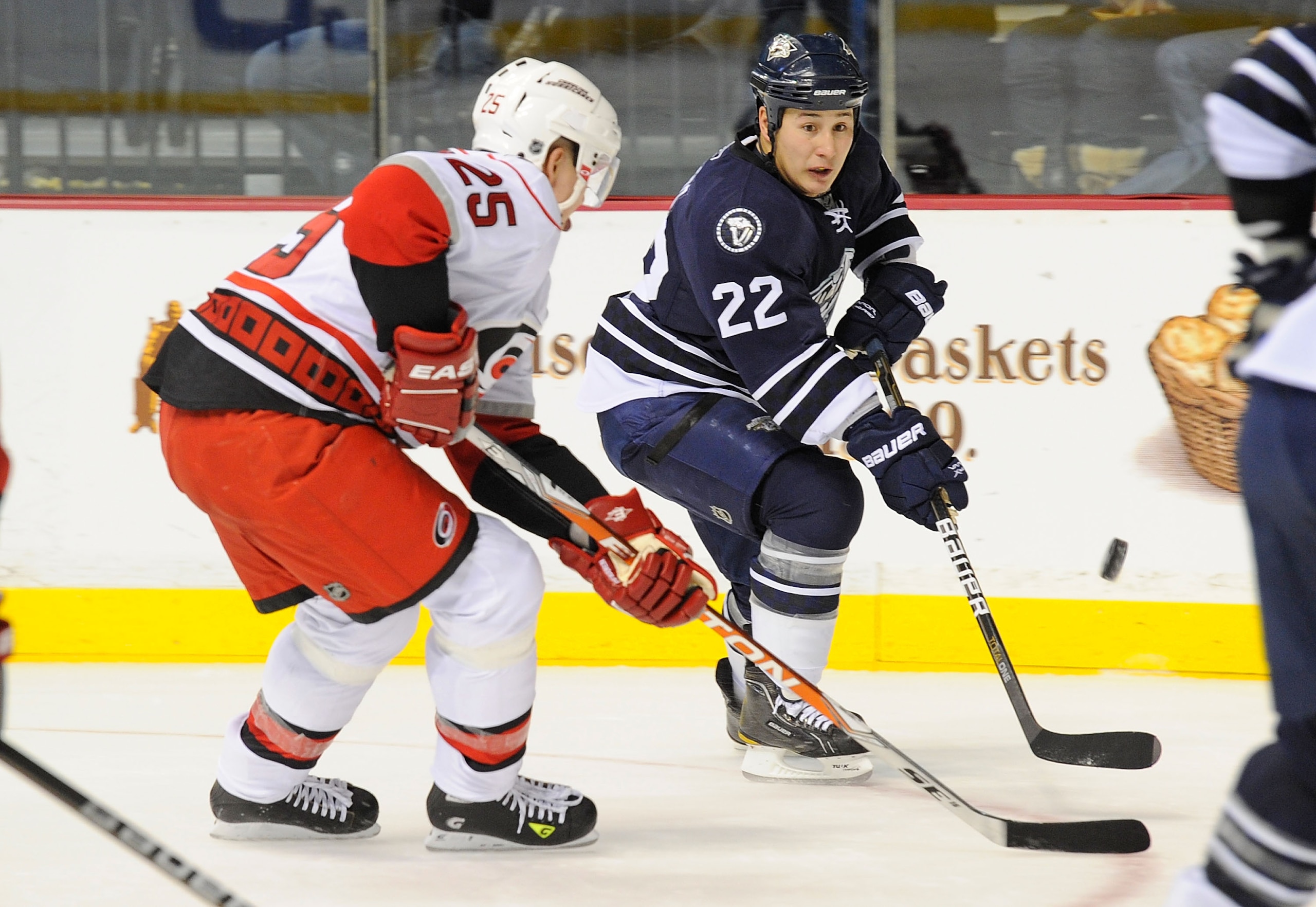 NASHVILLE, TN - DECEMBER 04:  Jordin Tootoo #22 of the Nashville Predators carries the puck past Joni Pitkanen #25 of the Carolina Hurricanes on December 4, 2010 at the Bridgestone Arena in Nashville, Tennessee.  (Photo by Frederick Breedon/Getty Images)