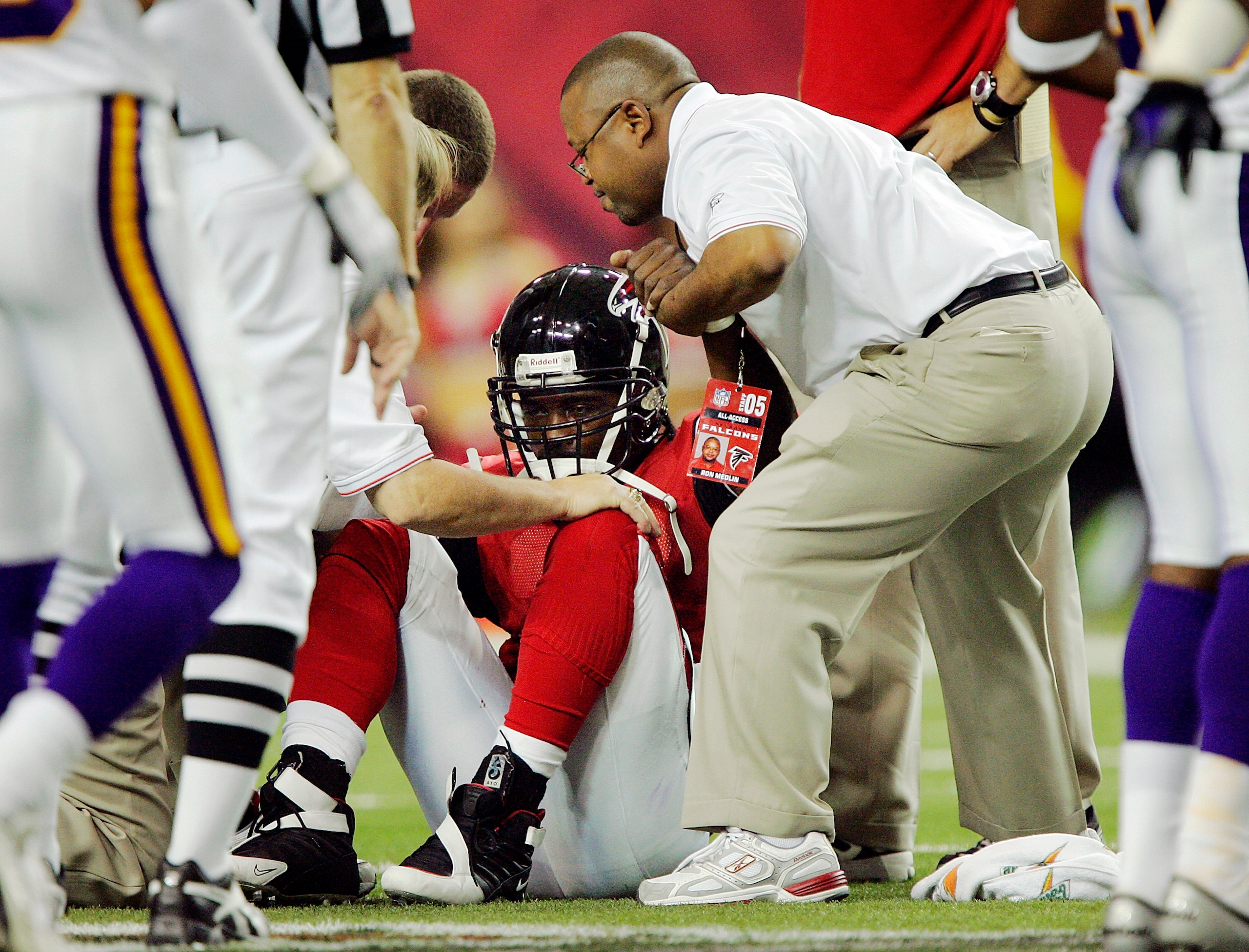 ATLANTA - OCTOBER 2:  Quarterback Michael Vick #7 of the Atlanta Falcons gets a hand up after injuring his knee against the Minnesota Vikings in the second quarter on October 2, 2005 at the Georgia Dome in Atlanta, Georgia.  The Falcons won 30-10.  (Photo