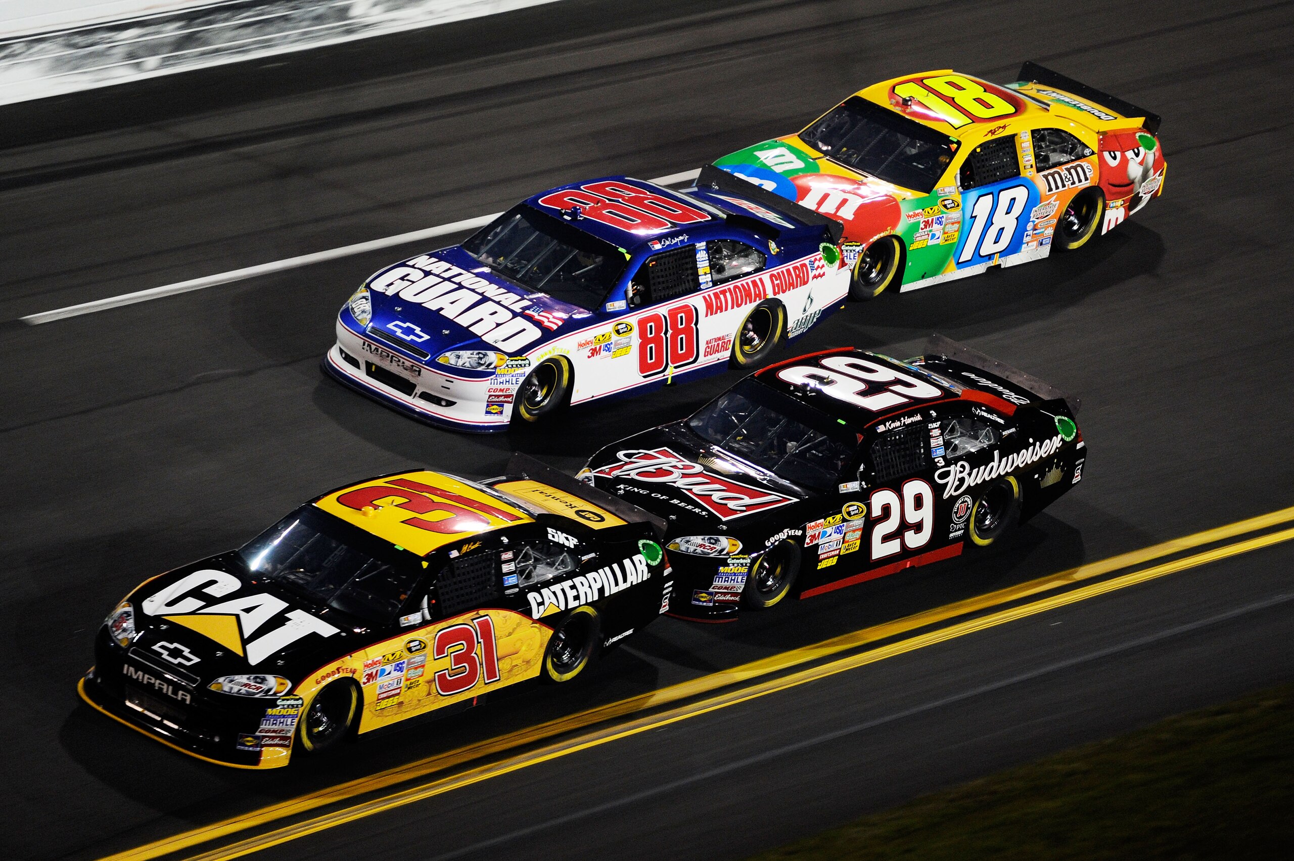 DAYTONA BEACH, FL - FEBRUARY 12: Jeff Burton, driver of the #31 Caterpilliar Chevrolet, leads Kevin Harvick, driver of the #29 Budweiser Chevrolet, Dale Earnhardt Jr., driver of the #88 National Guard/AMP Energy Chevrolet, and Kyle Busch, driver of the # DAYTONA BEACH, FL - FEBRUARY 12: Jeff Burton, driver of the #31 Caterpilliar Chevrolet, leads Kevin Harvick, driver of the #29 Budweiser Chevrolet, Dale Earnhardt Jr., driver of the #88 National Guard/AMP Energy Chevrolet, and Kyle Busch, driver of the #