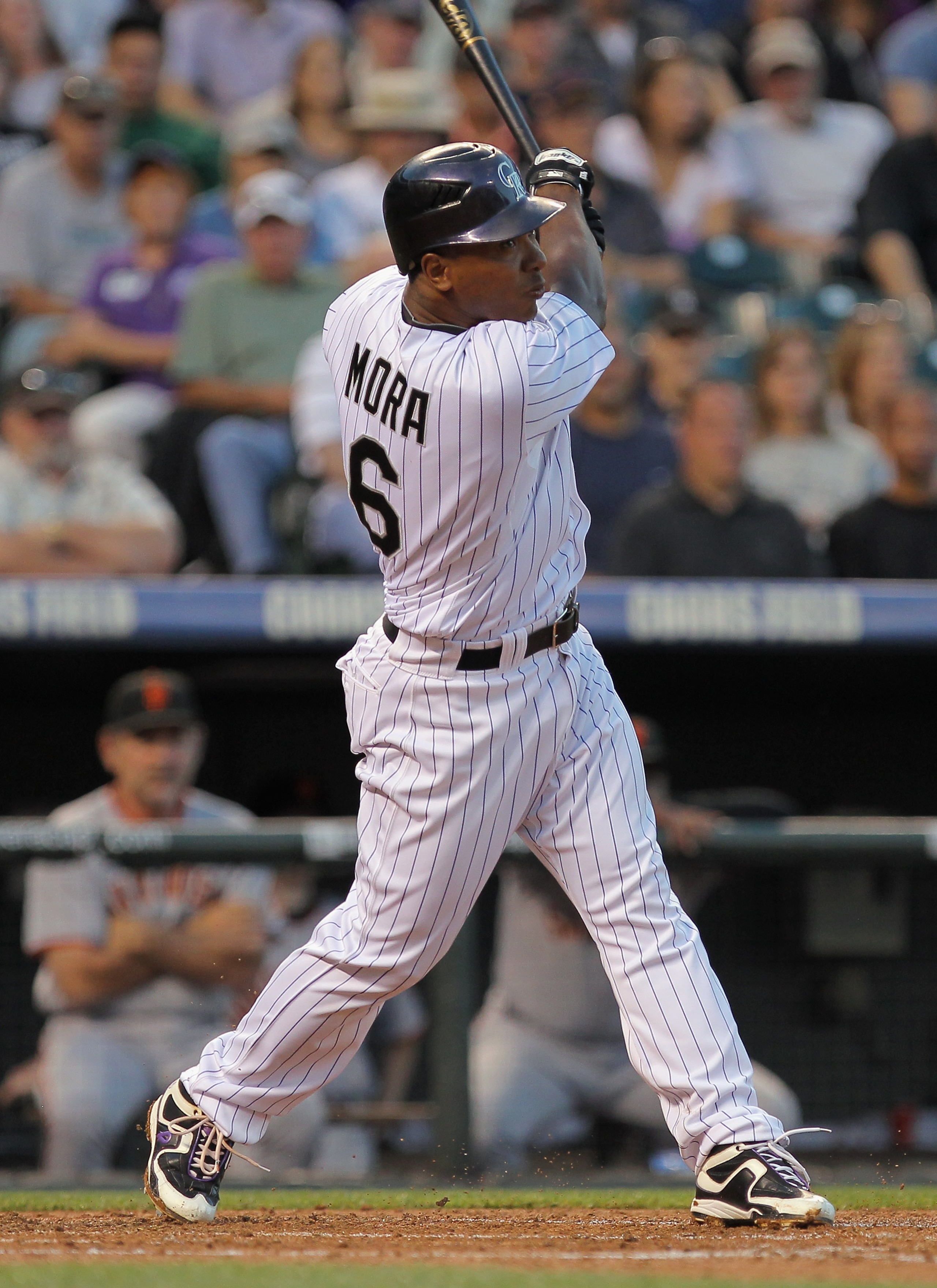 DENVER - SEPTEMBER 25: Melvin Mora #6 of the Colorado Rockies follows through on his two RBI single to rightfield off of starting pitcher Barry Zito of the San Francisco Giants at Coors Field on September 25, 2010 in Denver, Colorado. Troy Tulowitzki and DENVER - SEPTEMBER 25: Melvin Mora #6 of the Colorado Rockies follows through on his two RBI single to rightfield off of starting pitcher Barry Zito of the San Francisco Giants at Coors Field on September 25, 2010 in Denver, Colorado. Troy Tulowitzki and