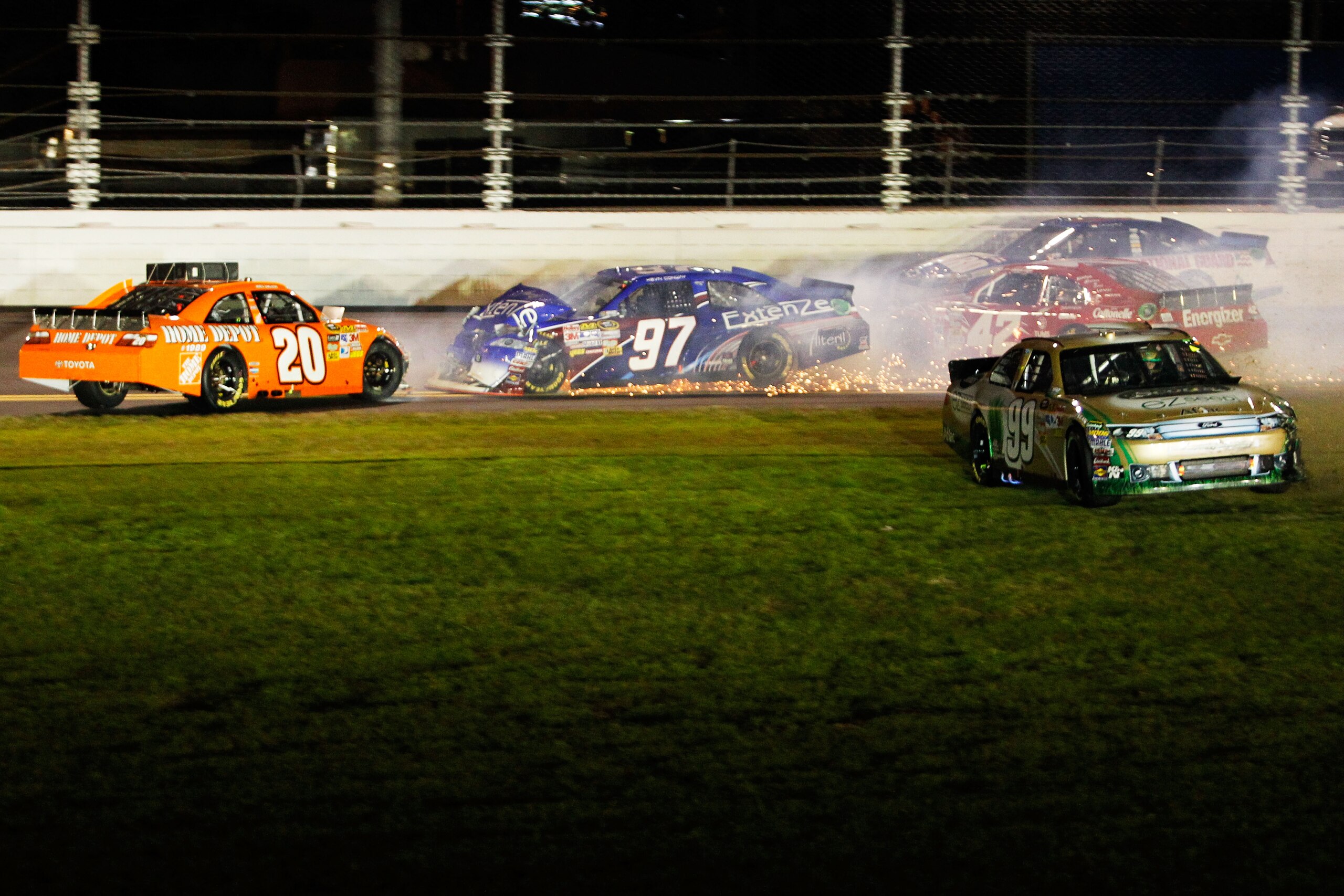 DAYTONA BEACH, FL - FEBRUARY 12: Carl Edwards, driver of the #99 Scotts Ford, drives through the grass after crashing with Joey Logano, driver of the #20 Home Depot Toyota, Juan Pablo Montoya, driver of the #42 Target Chevrolet, and Kevin Conway, driver DAYTONA BEACH, FL - FEBRUARY 12: Carl Edwards, driver of the #99 Scotts Ford, drives through the grass after crashing with Joey Logano, driver of the #20 Home Depot Toyota, Juan Pablo Montoya, driver of the #42 Target Chevrolet, and Kevin Conway, driver