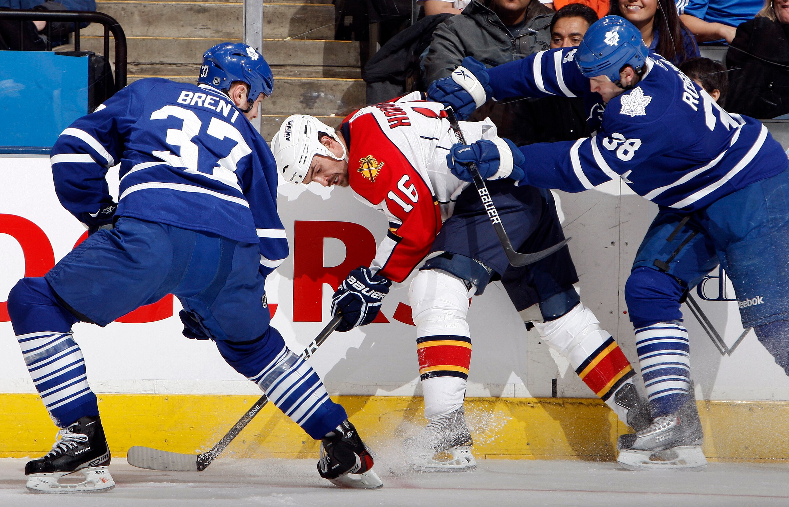 TORONTO, CANADA - FEBRUARY 1:  Tim Brent #37 and Jay Rosehill #38 of the Toronto Maple Leafs fight off Darcy Hordichuk #16 of the Florida Panthers during game action at the Air Canada Centre February 1, 2011 in Toronto, Ontario, Canada. (Photo by Abelimag