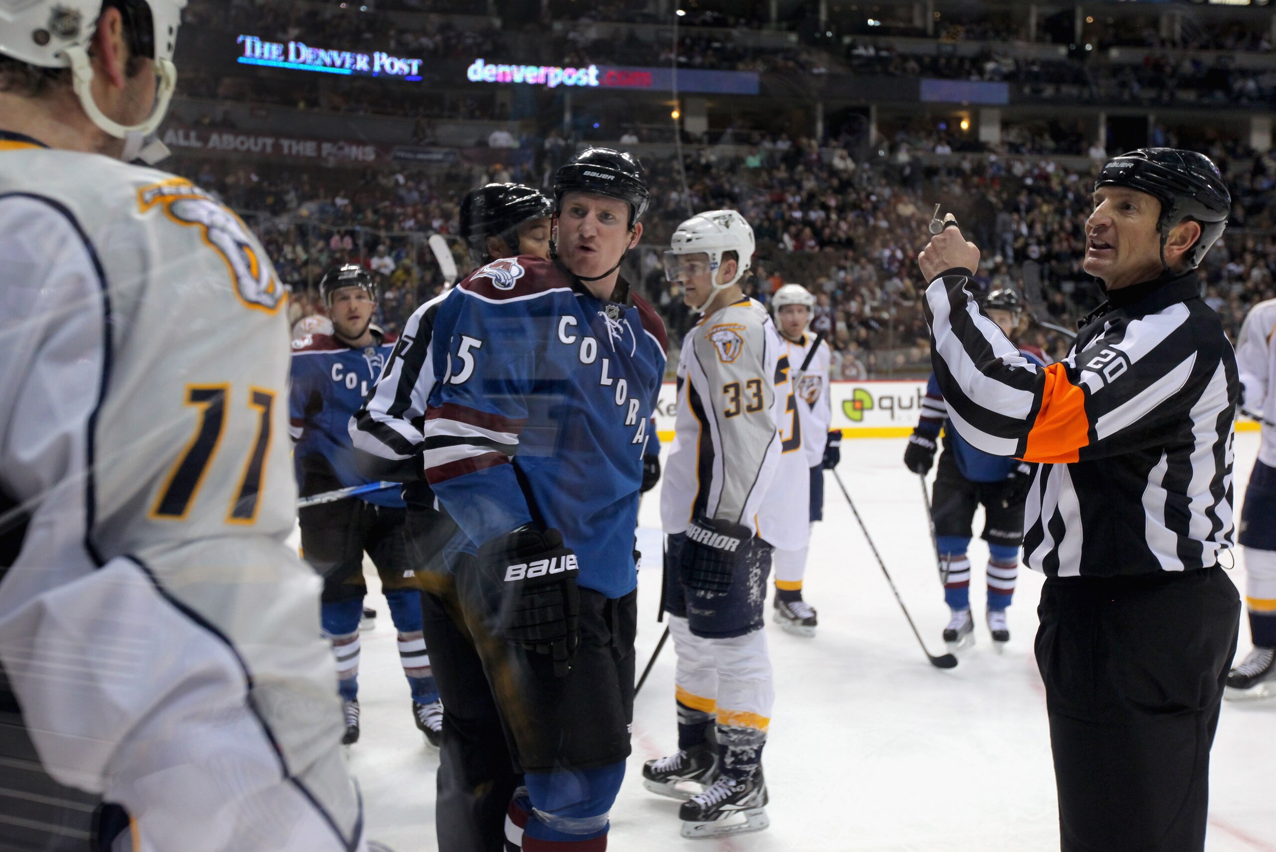 DENVER, CO - JANUARY 20:  Referee Tim Peel #20 makes a penalty call as Cody McLeod #55 of the Colorado Avalanche David Legwand #11 of the Nashville Predators observe at the Pepsi Center on January 20, 2011 in Denver, Colorado.  (Photo by Doug Pensinger/Ge