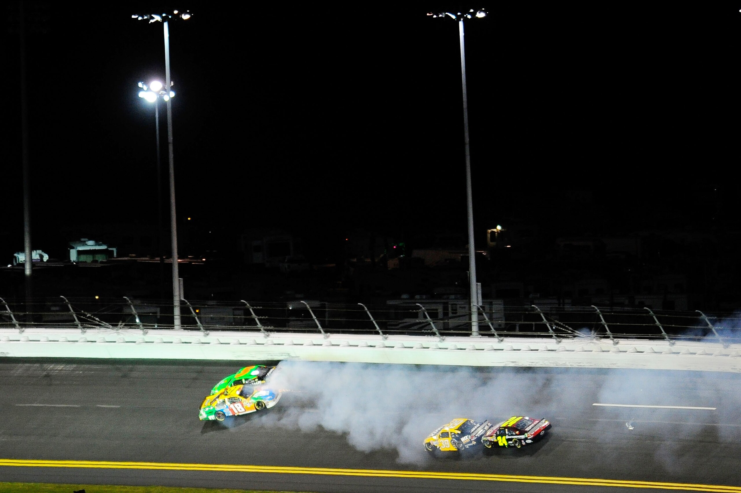 DAYTONA BEACH, FL - FEBRUARY 12: Kyle Busch, driver of the #18 M&M's Toyota, and Mark Martin, driver of the #5 GoDaddy.com Chevrolet, get tangled up in turn two during the NASCAR Budweiser Shootout at Daytona International Speedway on February 12, 2011 i DAYTONA BEACH, FL - FEBRUARY 12: Kyle Busch, driver of the #18 M&M's Toyota, and Mark Martin, driver of the #5 GoDaddy.com Chevrolet, get tangled up in turn two during the NASCAR Budweiser Shootout at Daytona International Speedway on February 12, 2011 i
