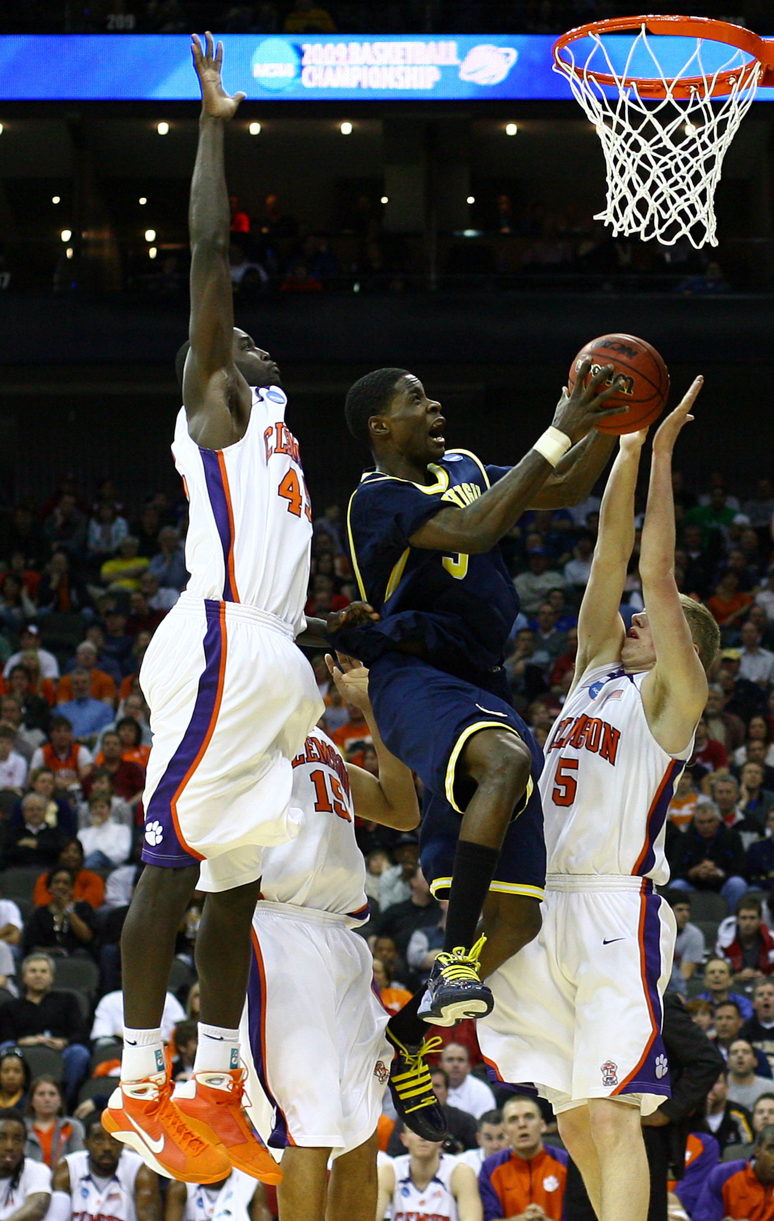 KANSAS CITY, MO - MARCH 19:  Manny Harris #3 of the Michigan Wolverines jumps to the basket for a scoring attempt against Tanner Smith #5 of the Clemson Tigers during the first round of the NCAA Division I Men's Basketball Tournament at the Sprint Center