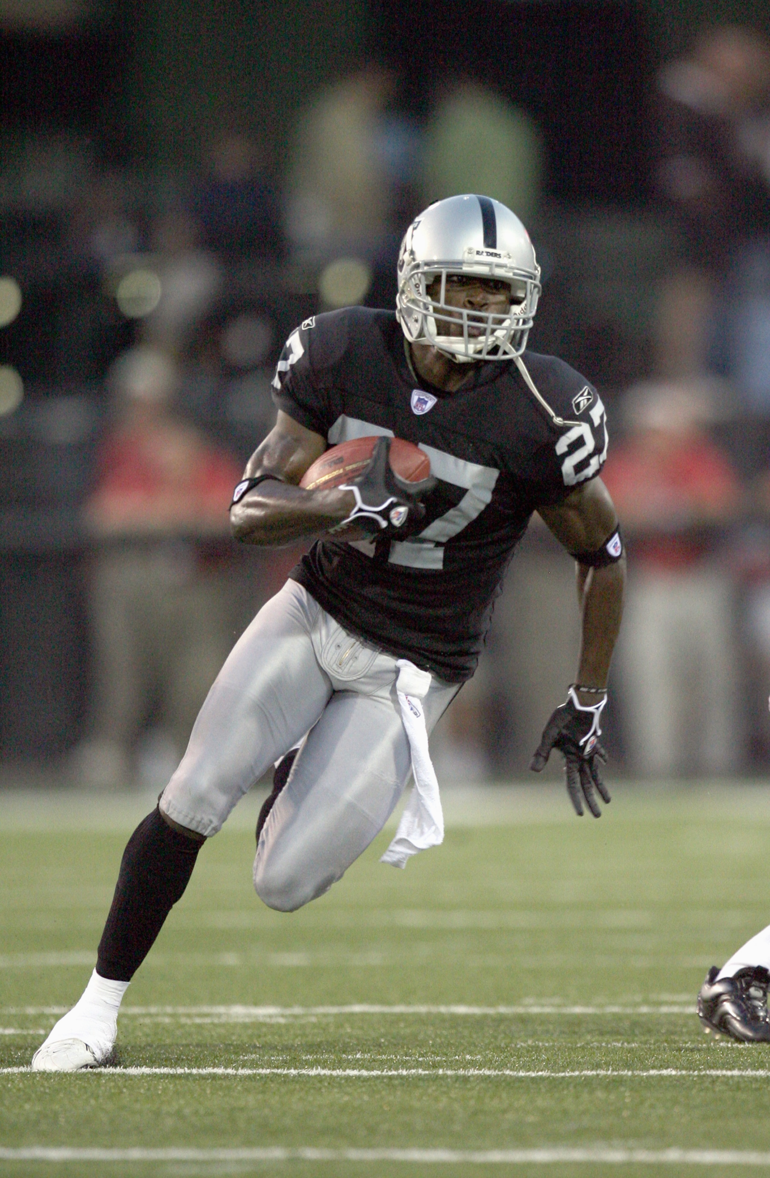 CANTON, OH - AUGUST 6:  Fabian Washington #27 of the Oakland Raiders carries the ball during the AFC-NFC Pro Football Hall of Fame Game against the Philadelphia Eagles at Fawcett Stadium on August 6, 2006 in Canton, Ohio. (Photo by Doug Benc/Getty Images)