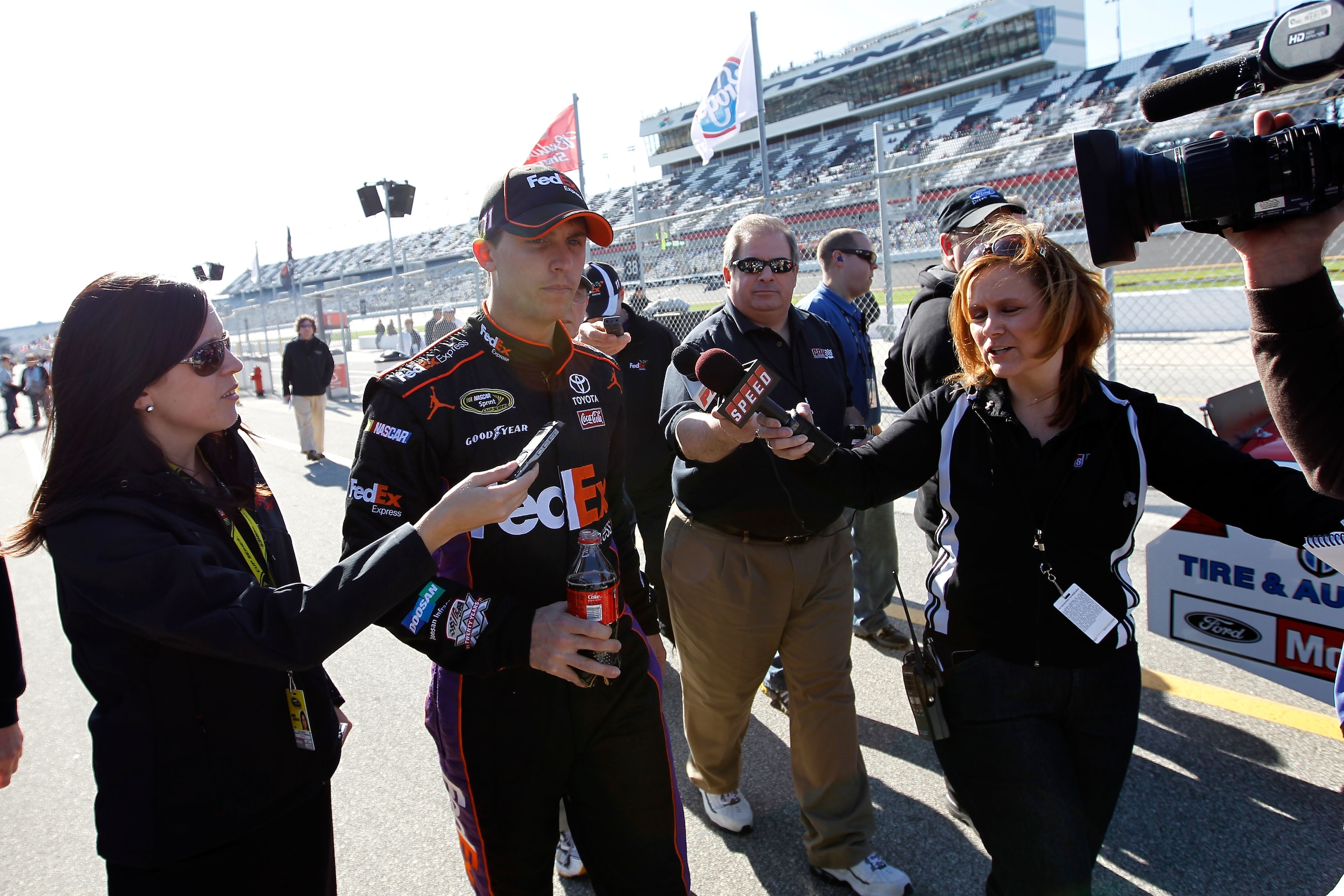DAYTONA BEACH, FL - FEBRUARY 13: Denny Hamlin, driver of the #11 FedEx Toyota, is interviewed after qualifying for the NASCAR Sprint Cup Series Daytona 500 at Daytona International Speedway on February 13, 2011 in Daytona Beach, Florida. (Photo by Tom P DAYTONA BEACH, FL - FEBRUARY 13: Denny Hamlin, driver of the #11 FedEx Toyota, is interviewed after qualifying for the NASCAR Sprint Cup Series Daytona 500 at Daytona International Speedway on February 13, 2011 in Daytona Beach, Florida. (Photo by Tom P