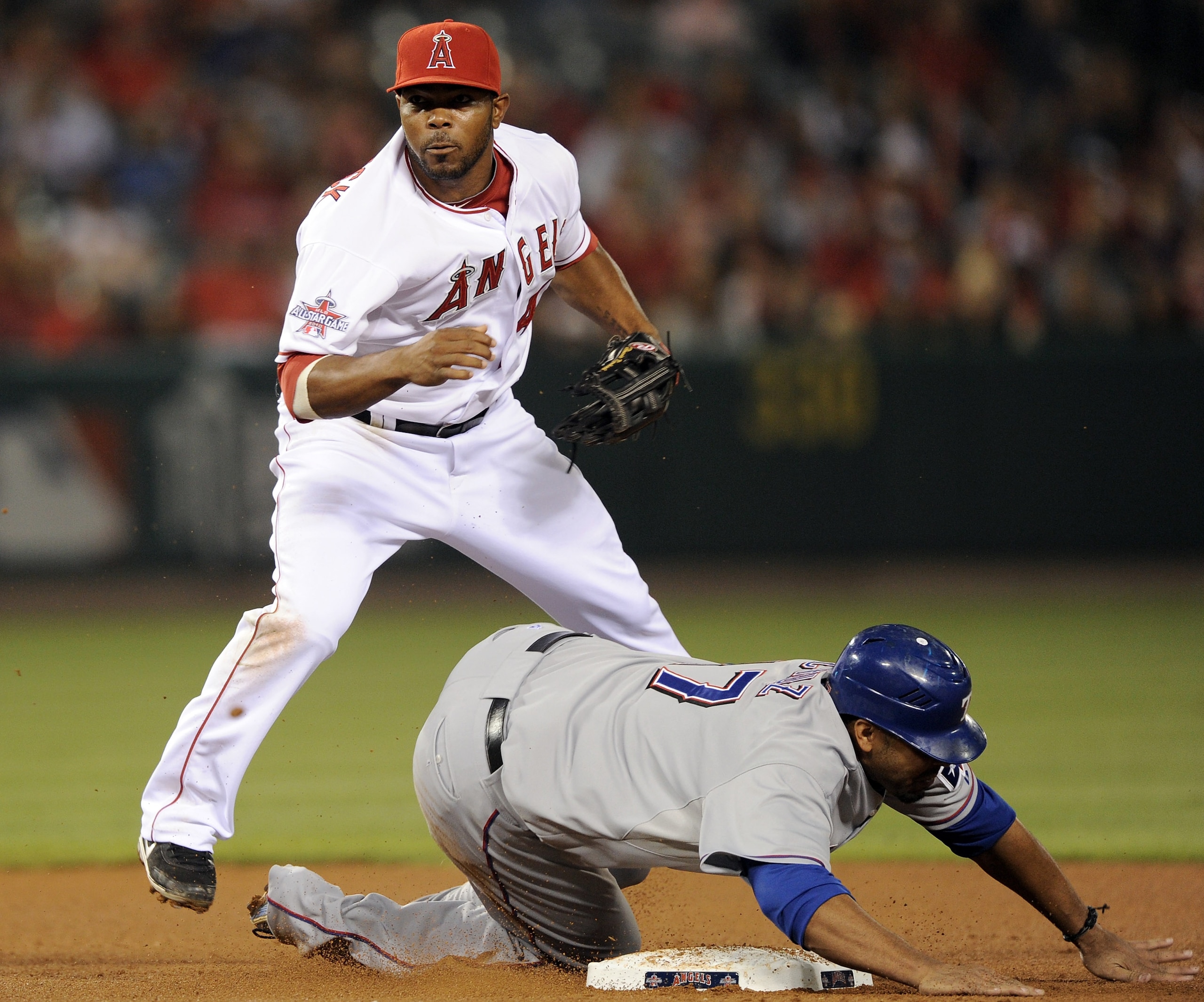 ANAHEIM, CA - SEPTEMBER 20:  Howie Kendrick #47 of the Los Angeles Angels of Anaheim makes a throw to first for a double play in front of a sliding Nelson Cruz #17 of the Texas Rangers during the fourth inning at Angel Stadium on September 20, 2010 in Ana