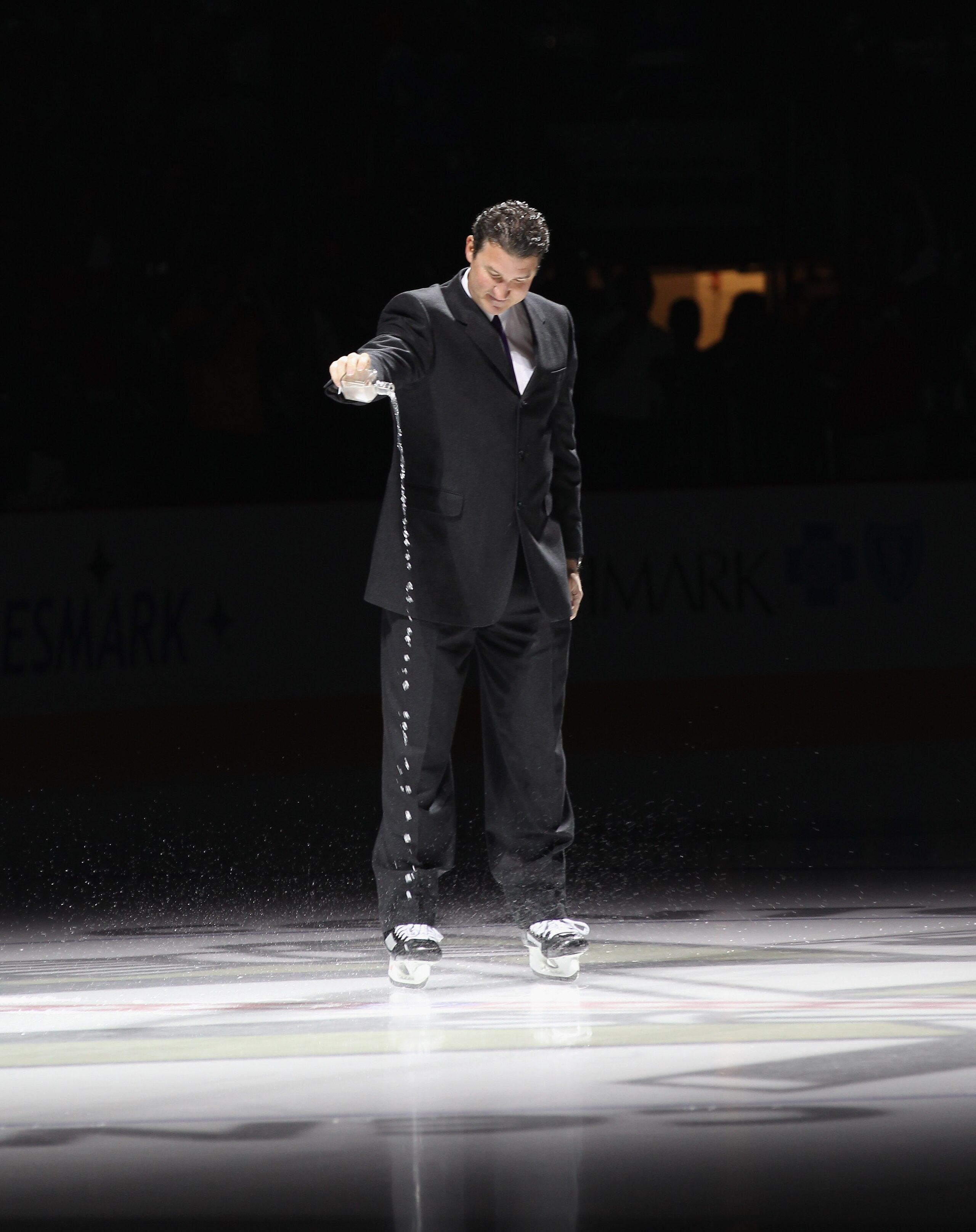 PITTSBURGH - OCTOBER 07:  Team owner Mario Lemieux of the Pittsburgh Penguins accompanied with water from the Mellon Arena salutes the crowd prior to the arena opening game against the Philadelphia Flyers at the Consol Energy Center on October 7, 2010 in