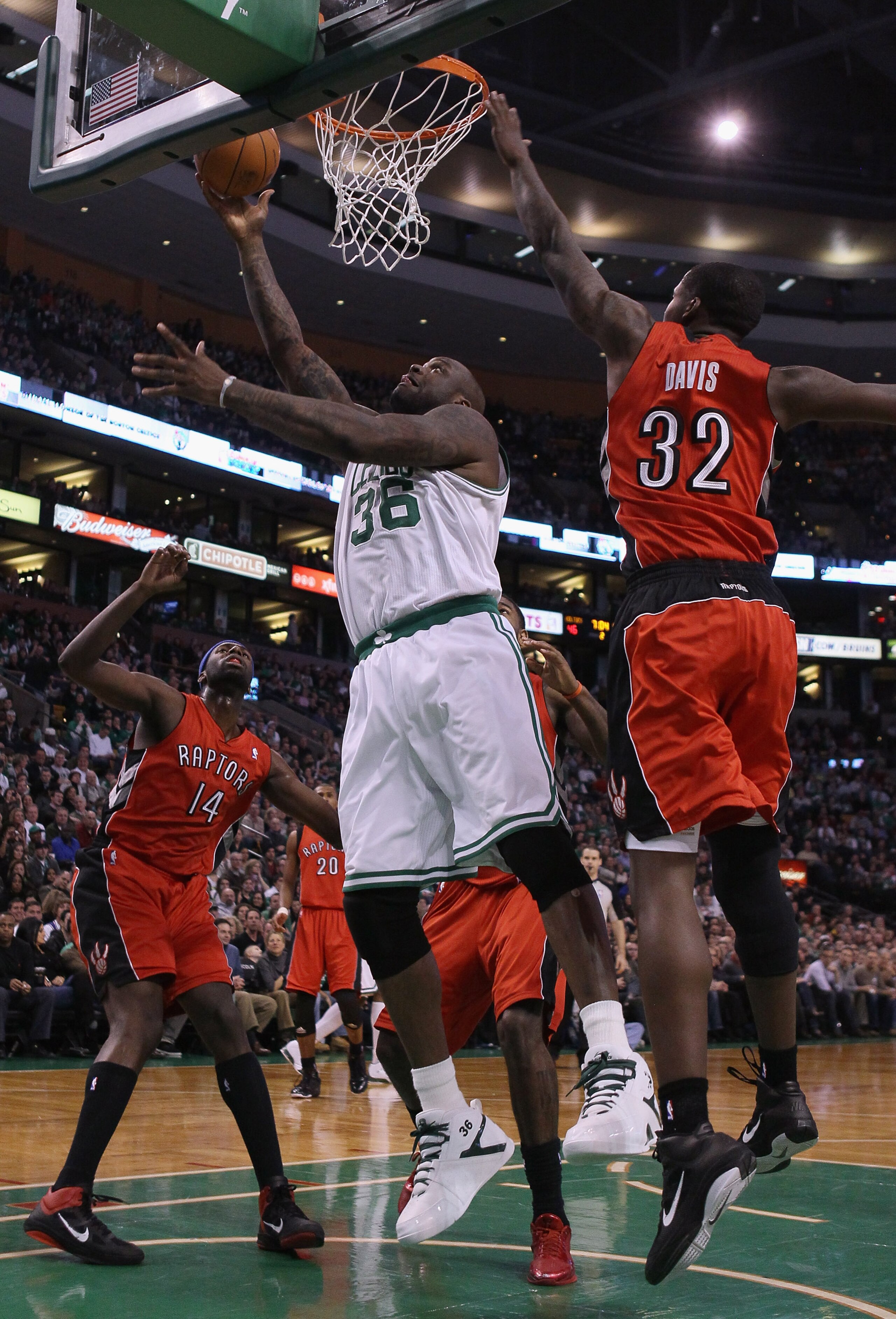 BOSTON, MA - JANUARY 07:  Shaquille O'Neal #36 of the Boston Celtics heads for the basket as Julian Wright #14 and Ed Davis #32 of the Toronto Raptors defend on January 7, 2011 at the TD Garden in Boston, Massachusetts. NOTE TO USER: User expressly acknow