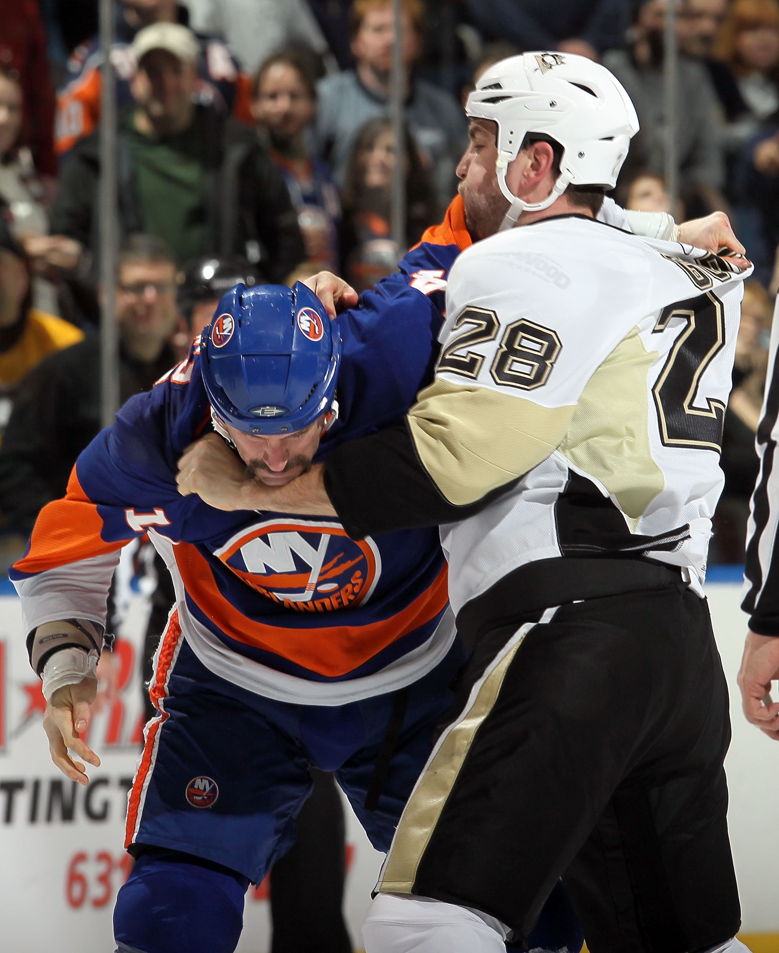 UNIONDALE, NY - FEBRUARY 11:  Eric Godard #28 of the Pittsburgh Penguins fights Trevor Gillies #14 of the New York Islanders during the first period on February 11, 2011 at Nassau Coliseum in Uniondale, New York.  (Photo by Jim McIsaac/Getty Images)