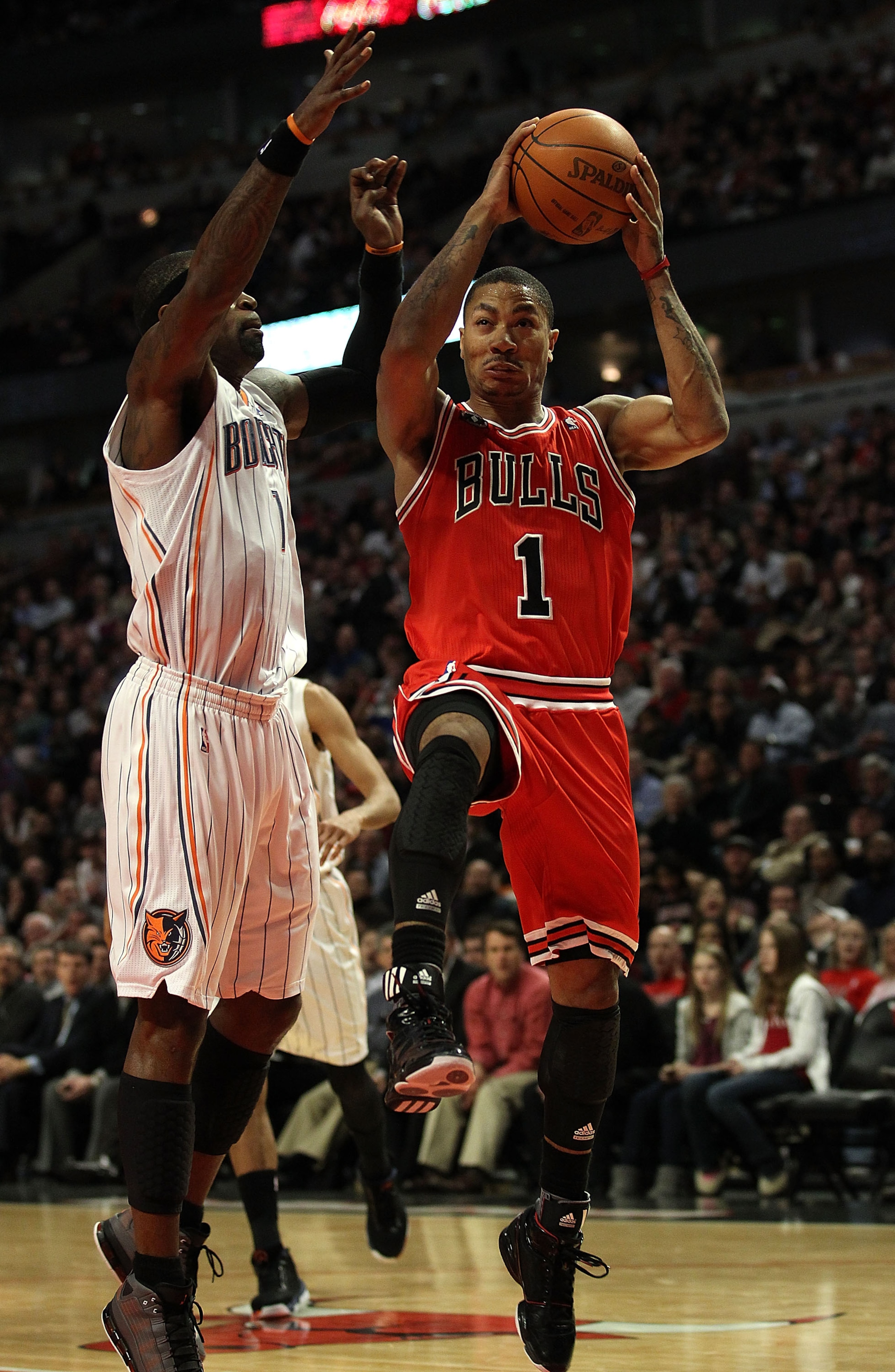 CHICAGO, IL - FEBRUARY 15: Derrick Rose #1 of the Chicago Bulls drives past Stephen Jackson #1 of the Charlotte Bobcats at the United Center on February 15, 2011 in Chicago, Illinois. The Bulls defeated the Bobcats 106-94. NOTE TO USER: User expressly ack