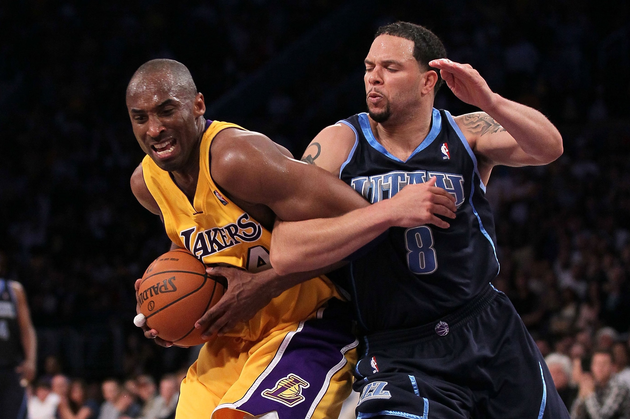 LOS ANGELES, CA - MAY 04:  Kobe Bryant #24 of the Los Angeles Lakers gets tied up with Deron Williams #8 of the Utah Jazz in the fourth quarter during Game Two of the Western Conference Semifinals of the 2010 NBA Playoffs at Staples Center on May 4, 2010