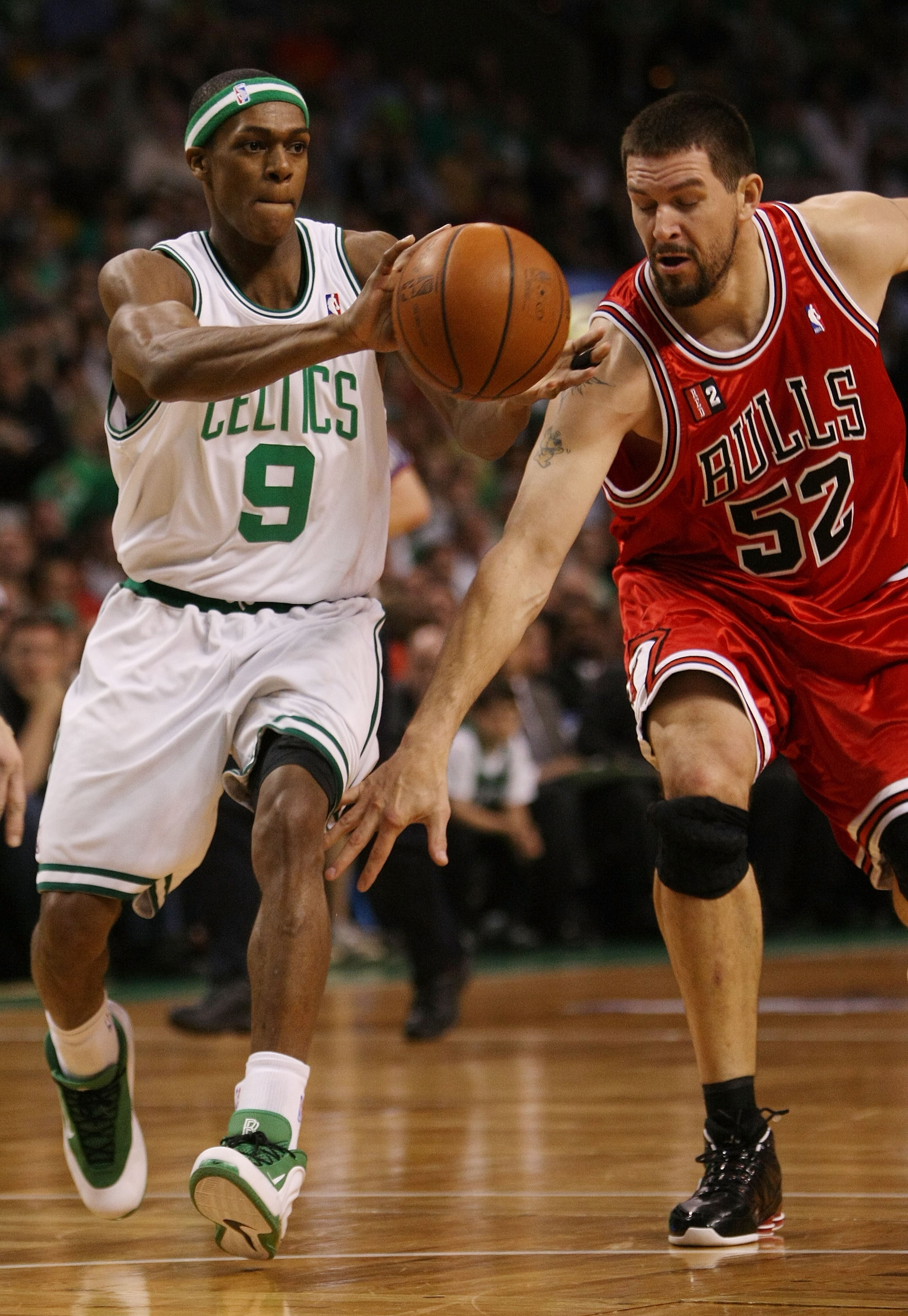 BOSTON - APRIL 28:  Brad Miller #52 of the Chicago Bulls tries to steal the ball from Rajon Rondo #9 of the Boston Celtics in Game Five of the Eastern Conference Quarterfinals during the 2009 NBA Playoffs at TD Banknorth Garden on April 28, 2009 in Boston