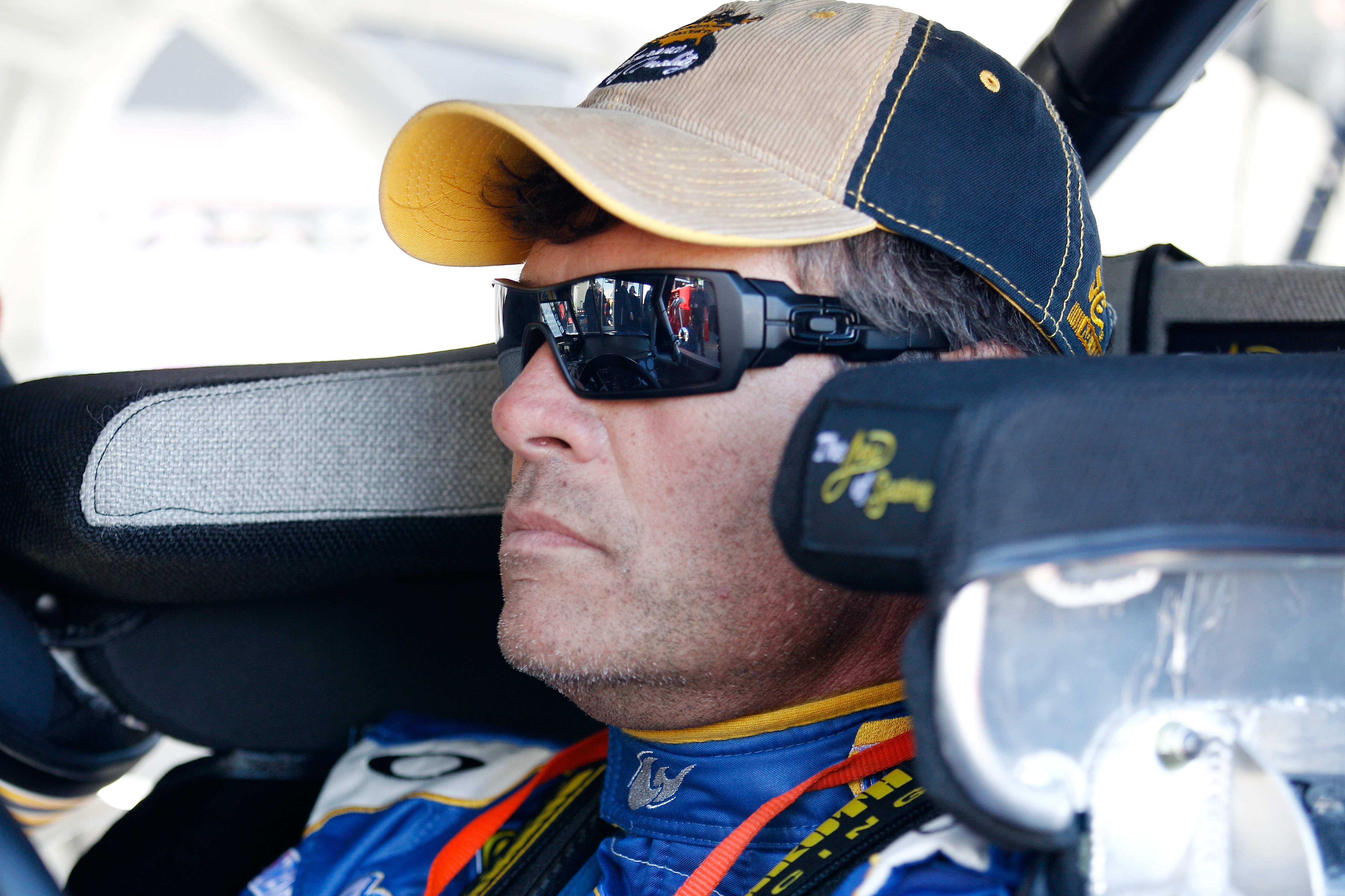 DAYTONA BEACH, FL - FEBRUARY 12:  Michael Waltrip, driver of the #15 NAPA Toyota, sits in his car during practice for the NASCAR Sprint Cup Series Daytona 500 at Daytona International Speedway on February 12, 2011 in Daytona Beach, Florida.  (Photo by Chr