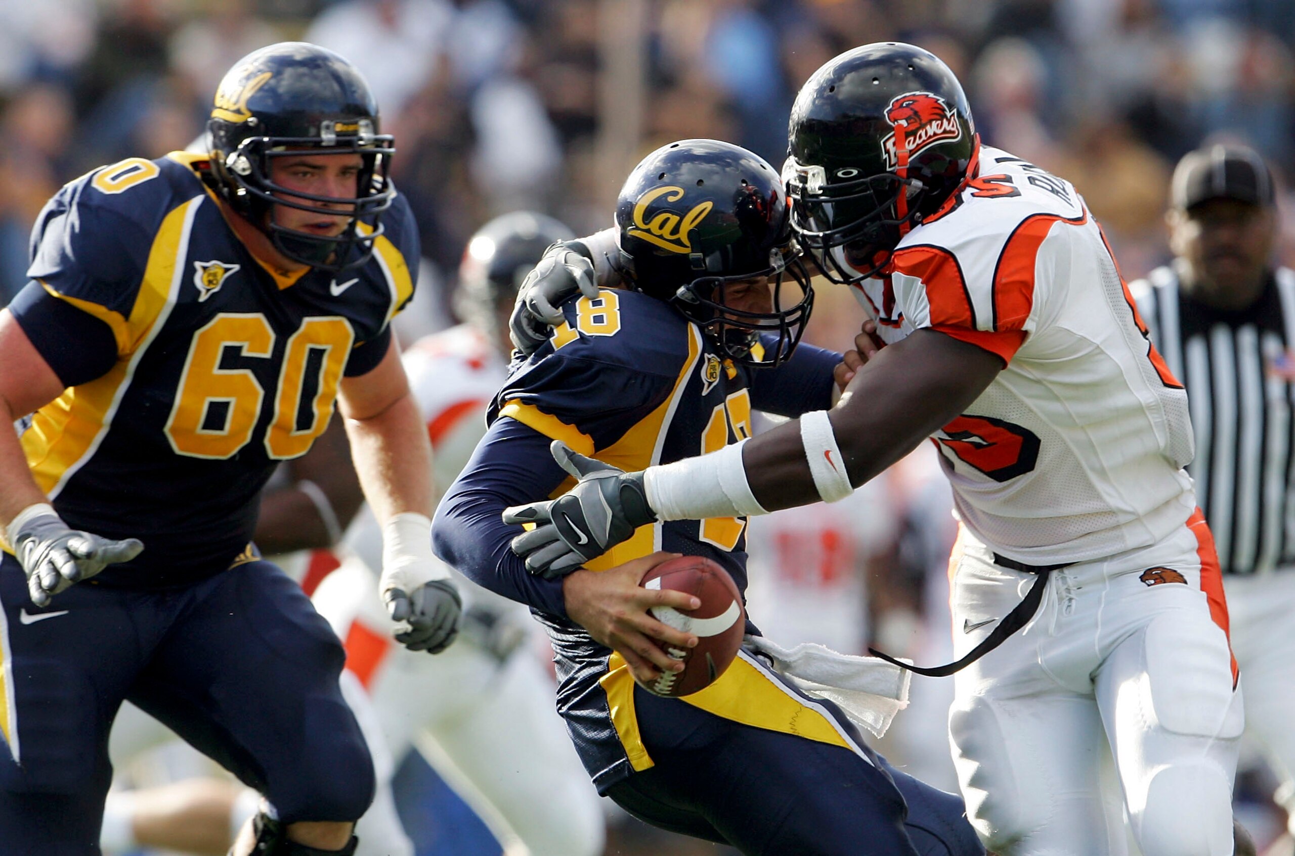 BERKELEY, CA - OCTOBER 15:  Quarterback Joe Ayoob #18 of the California Golden Bears is tackled by Joe Rudulph #95 of the Oregon State Beavers during the fourth quarter of the game at Memorial Stadium on October 15, 2005 in Berkeley, California. Oregon St