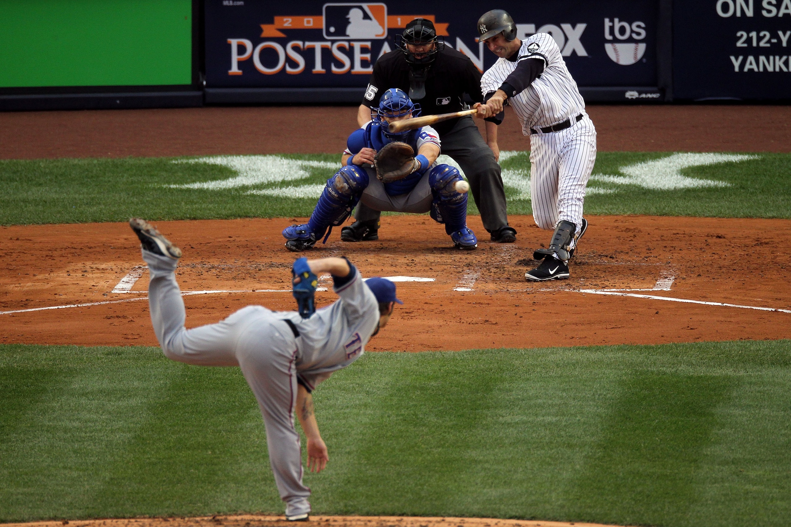 NEW YORK - OCTOBER 20:  Jorge Posada #20 of the New York Yankees hits a RBI single in the bottom of the second inning against the Texas Rangers in Game Five of the ALCS during the 2010 MLB Playoffs at Yankee Stadium on October 20, 2010 in the Bronx boroug