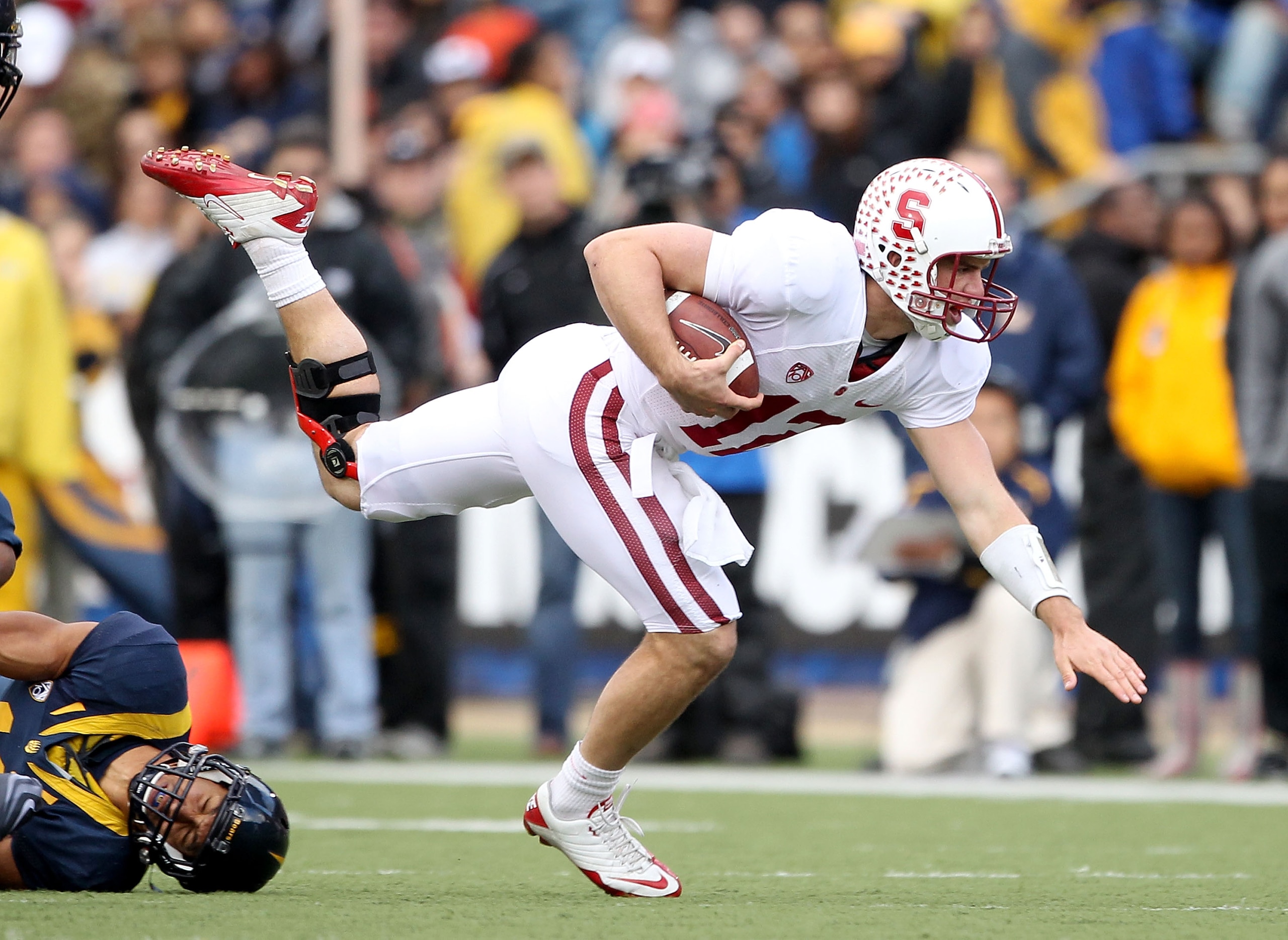 BERKELEY, CA - NOVEMBER 20:  Andrew Luck #12 of the Stanford Cardinal jumps over Sean Cattouse #11  the California Golden Bears at California Memorial Stadium on November 20, 2010 in Berkeley, California.  (Photo by Ezra Shaw/Getty Images)