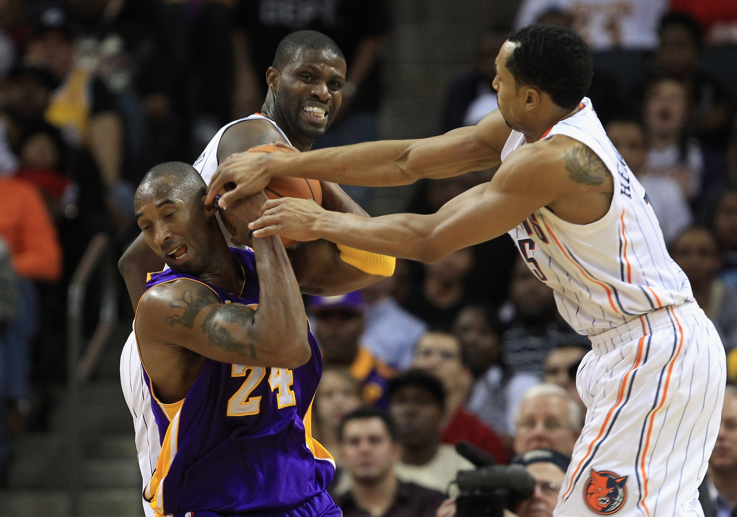 CHARLOTTE, NC - FEBRUARY 14: Kobe Bryant #24 of the Los Angeles Lakers battles for a loose ball with teammates Nazr Mohammed #13 and Gerald Henderson #15 of the Charlotte Bobcats during their game at Time Warner Cable Arena on February 14, 2011 in Charlo CHARLOTTE, NC - FEBRUARY 14: Kobe Bryant #24 of the Los Angeles Lakers battles for a loose ball with teammates Nazr Mohammed #13 and Gerald Henderson #15 of the Charlotte Bobcats during their game at Time Warner Cable Arena on February 14, 2011 in Charlo