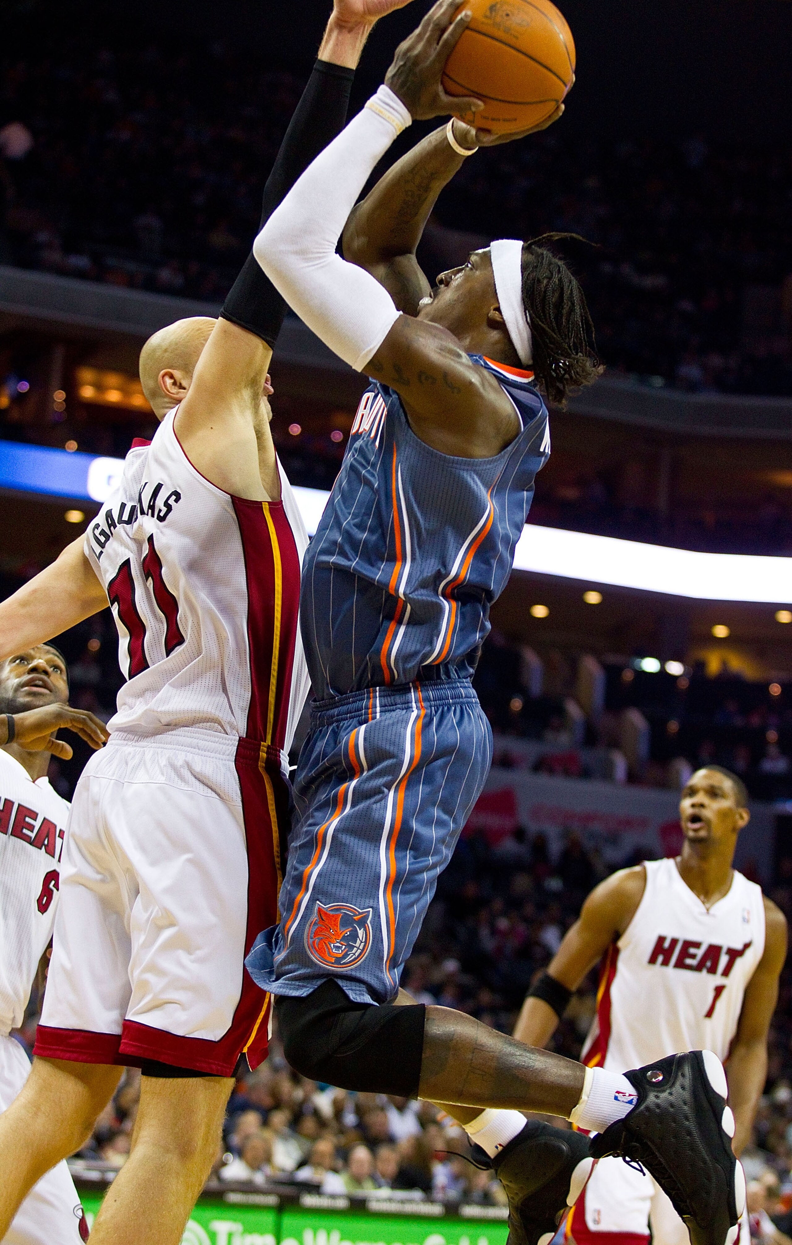 CHARLOTTE, NC - FEBRUARY 04:  Gerald Wallace #3 of the Charlotte Bobcats shoots over Zydrunas Ilgauskus #11 of the Miami Heat at the Time Warner Cable Arena on February 4, 2011 in Charlotte, North Carolina.  The Heat defeated the Bobcats 109-97.  NOTE TO
